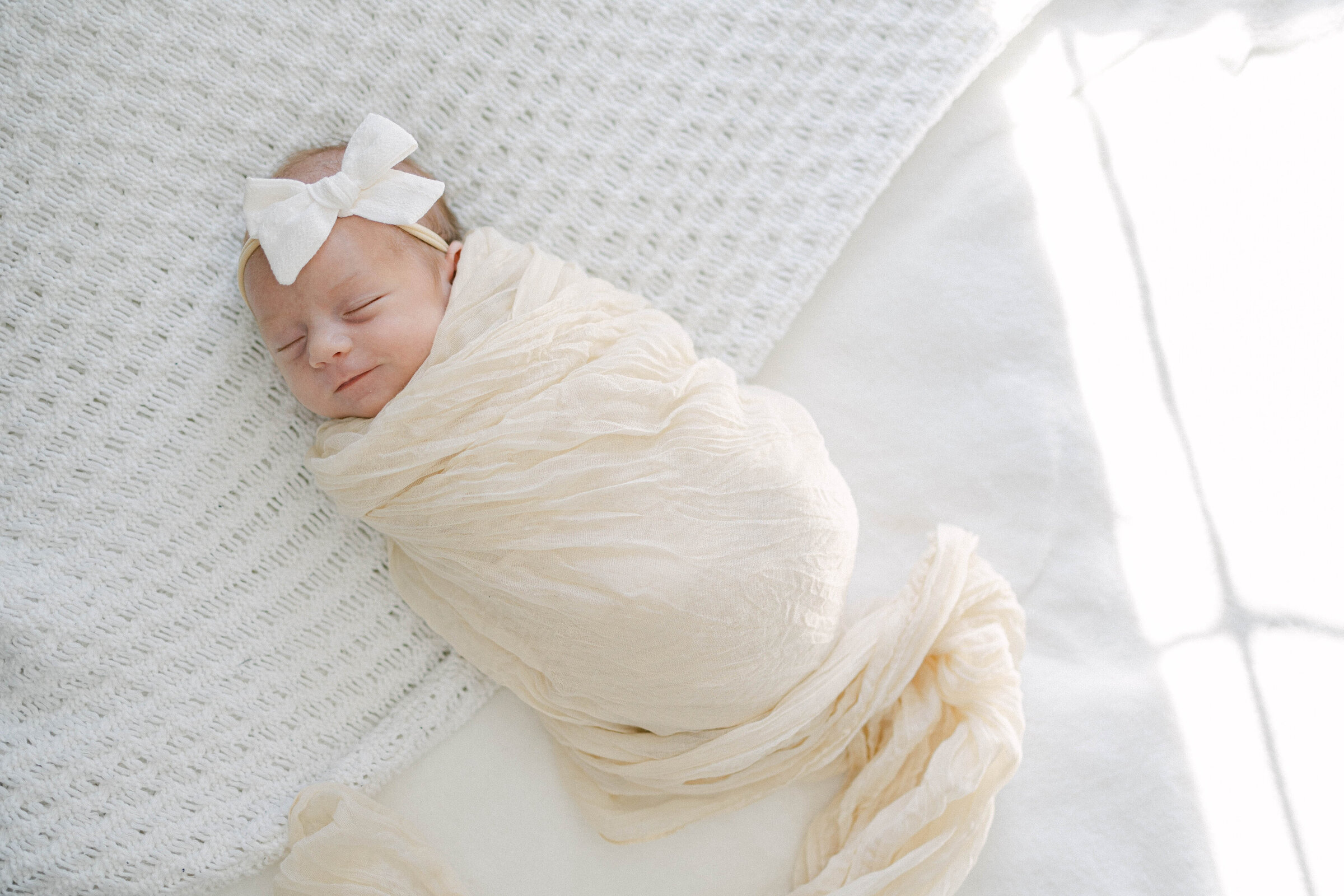 swaddled newborn on bed knoxville tennessee newborn photographer