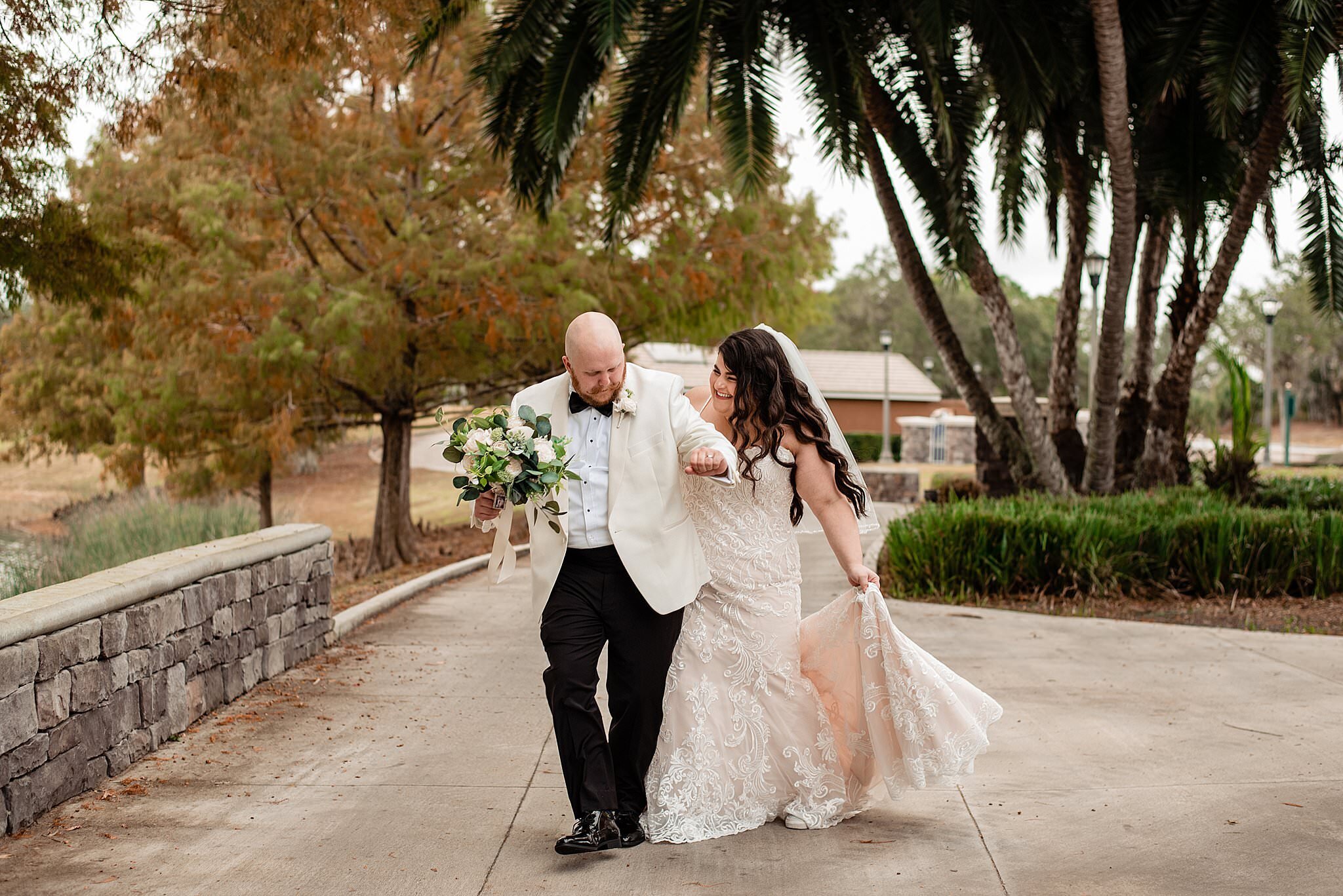 Couple laughing and walking together under palm trees in Orlando