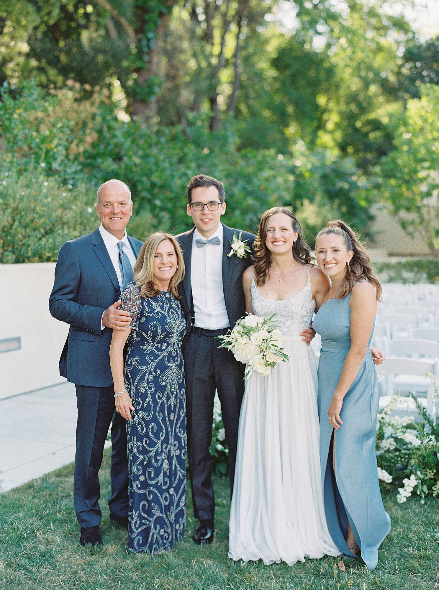 family formal photo at blue and white wedding outdoors in california