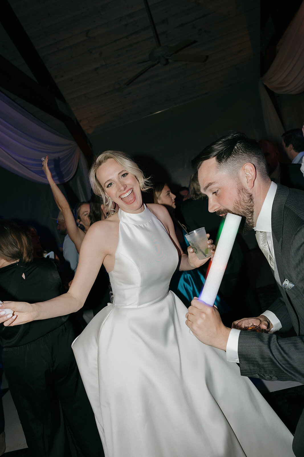 A bride and groom dancing to the beat of the music at their reception. 