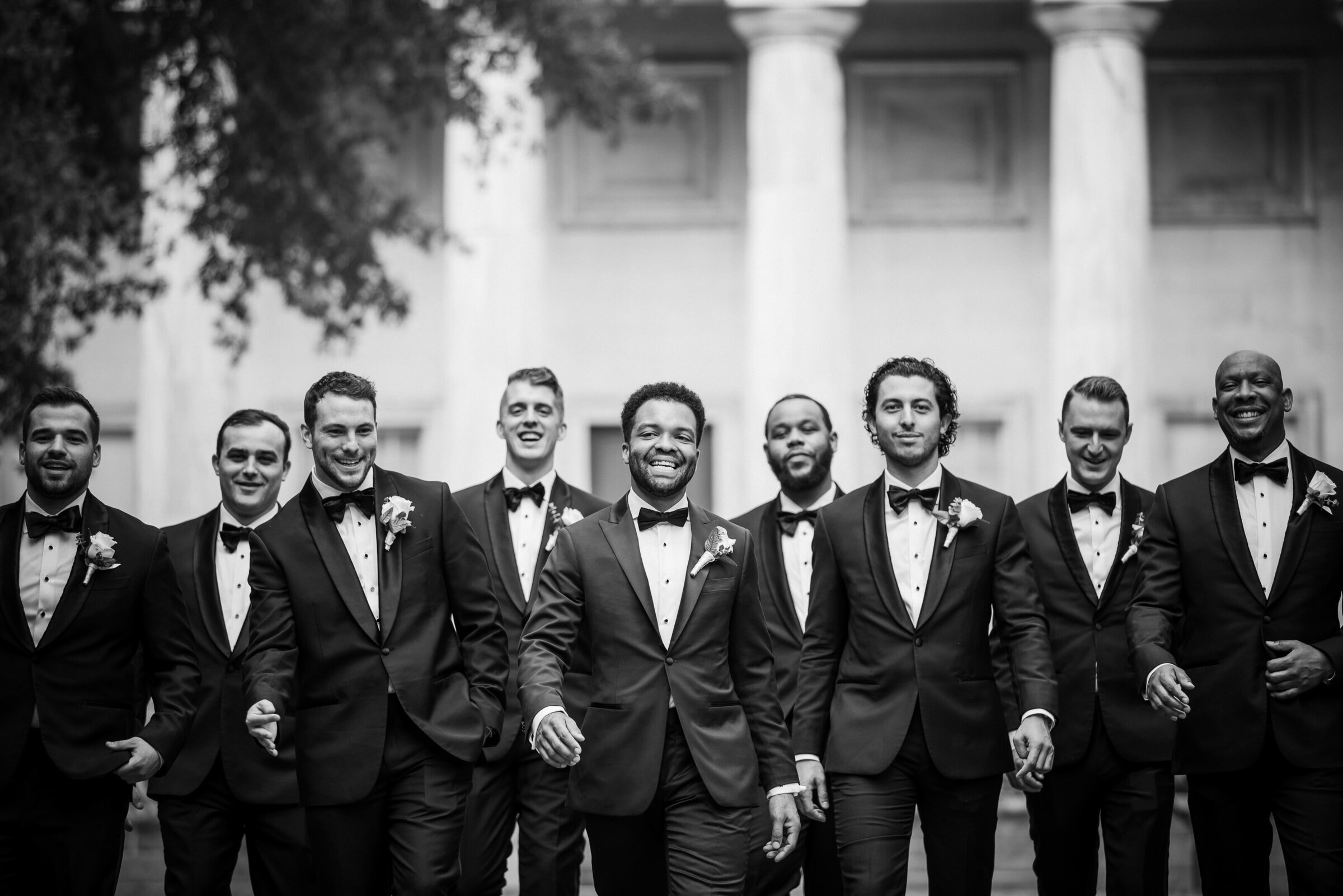 Black groom with his eight groomsmen walking candidly in Old City Philadelphia
