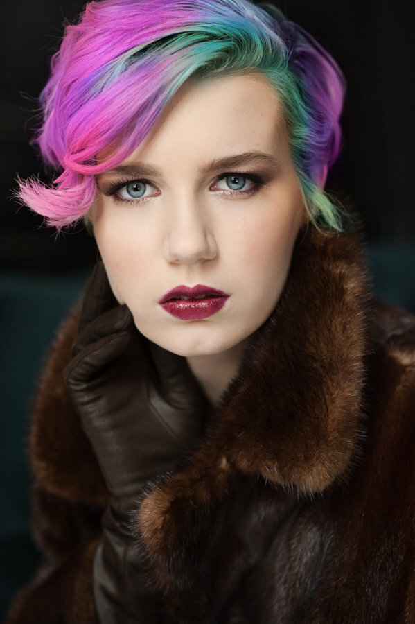 Eden Prairie Minnesota high school senior photo of girl with rainbow hair in fur coat against black background in studio