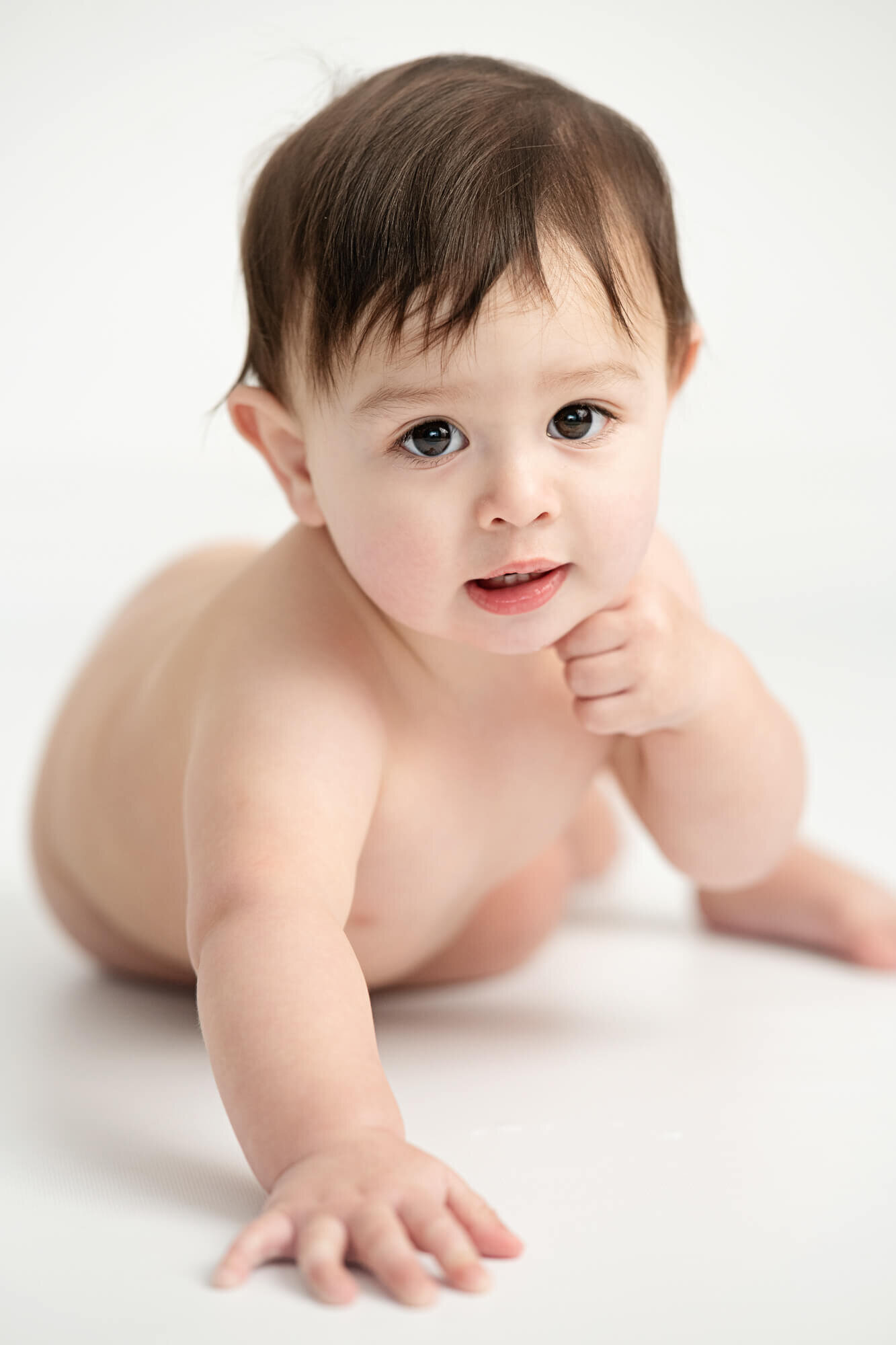 Baby boy with white background looking into camera