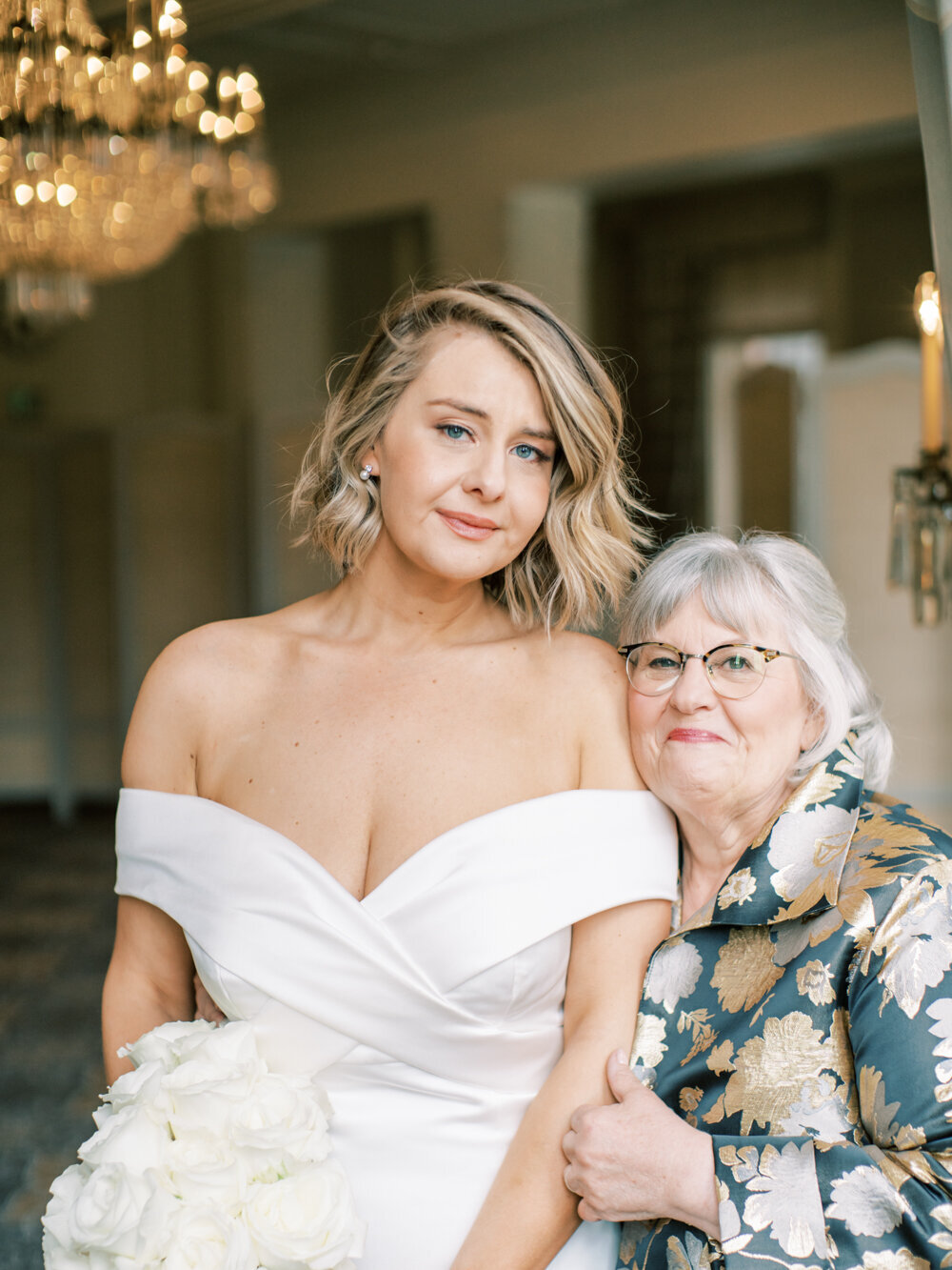 emotional teary eyed bride posing for a portrait with her mother