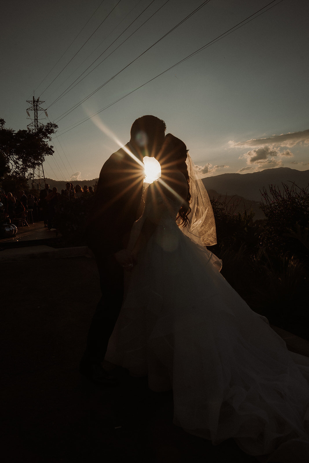 couple kissing at sunset on the mountains wedding