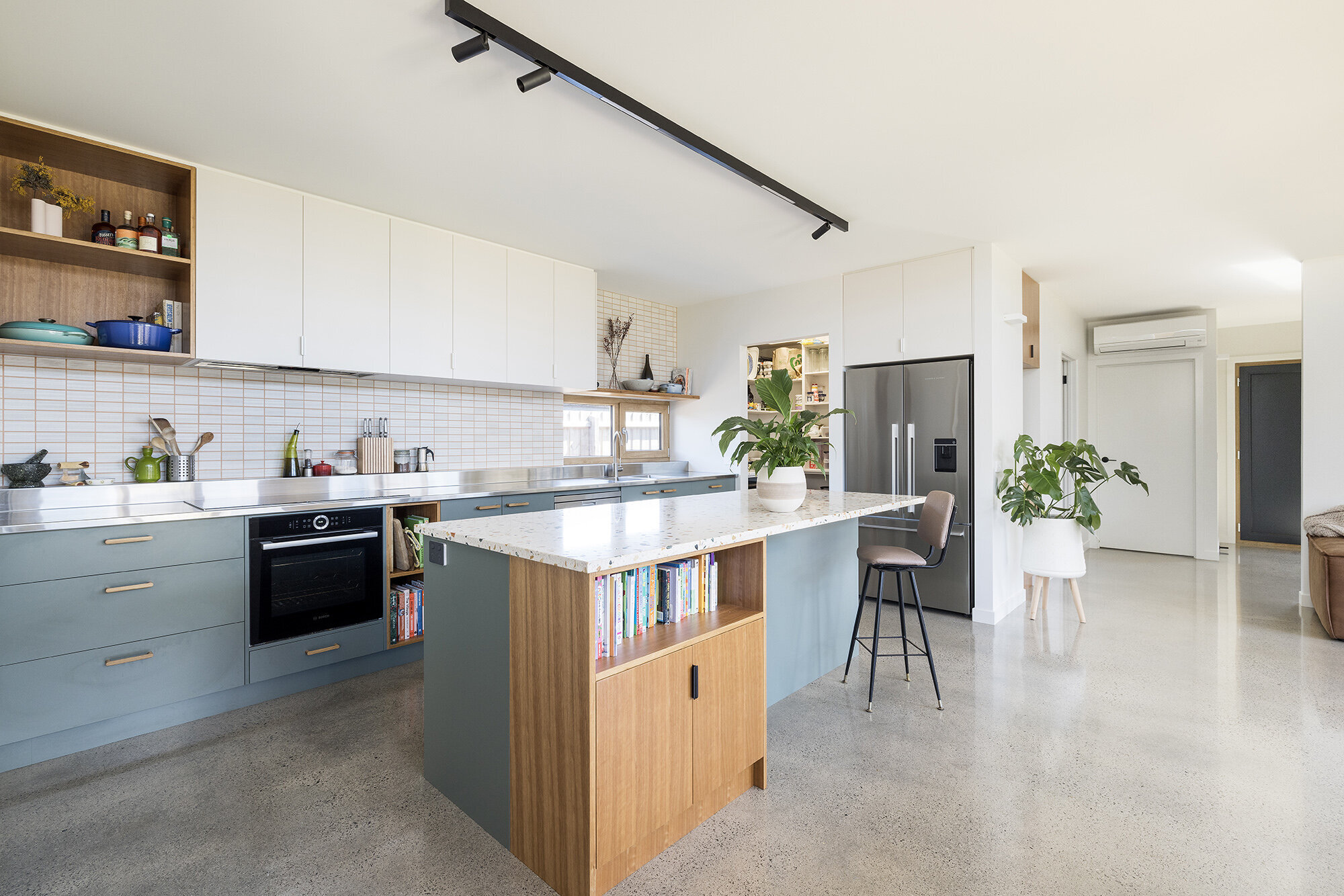sustainable home polished concrete floor blue kitchen