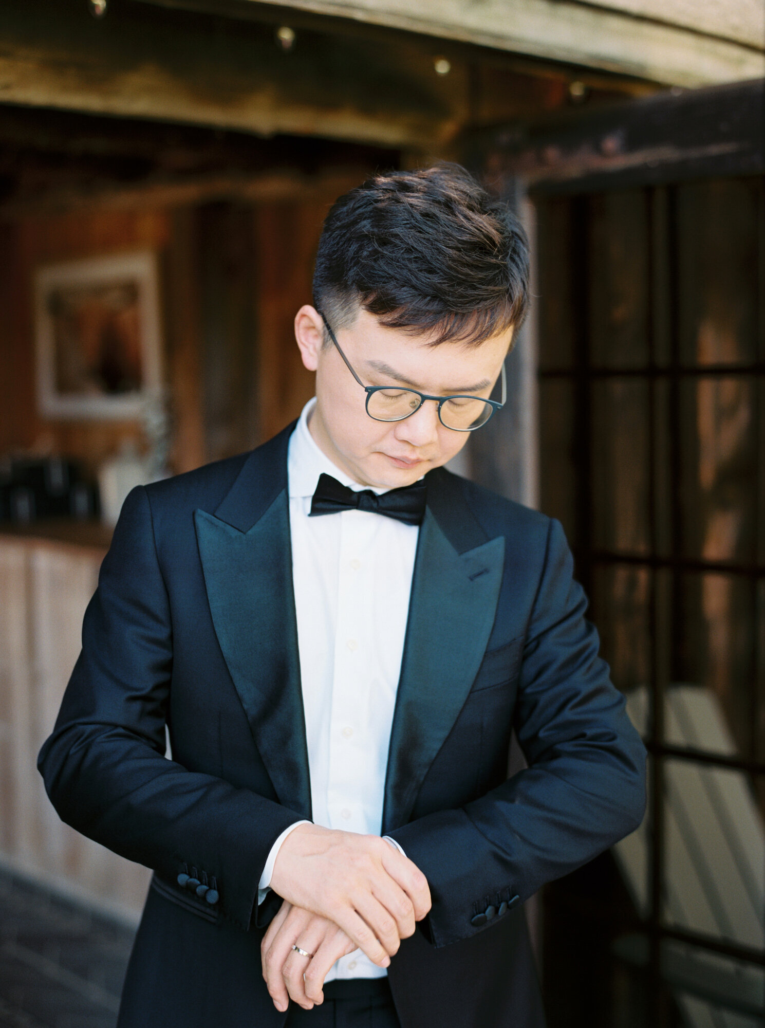 chinese groom in black tie tux at wedding