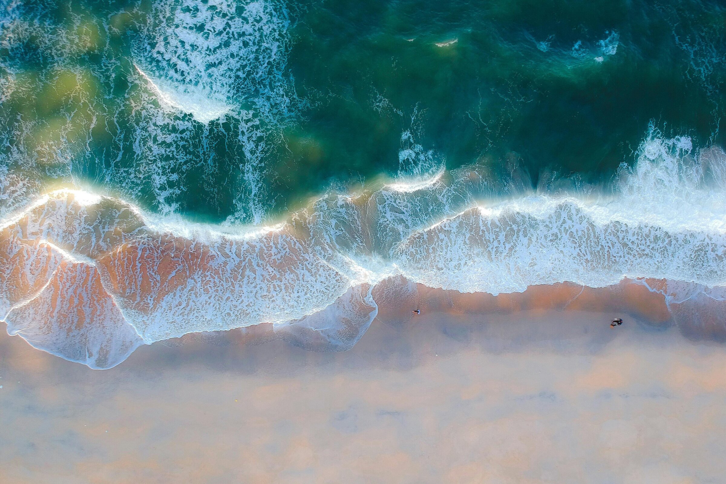 Image of aerial view of waves crashing on beach