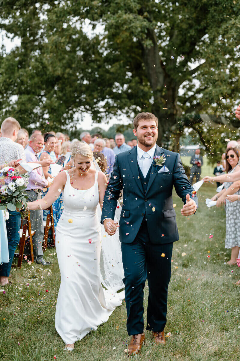 Bride and groom walking down aisle taken by wedding photographers in lexington