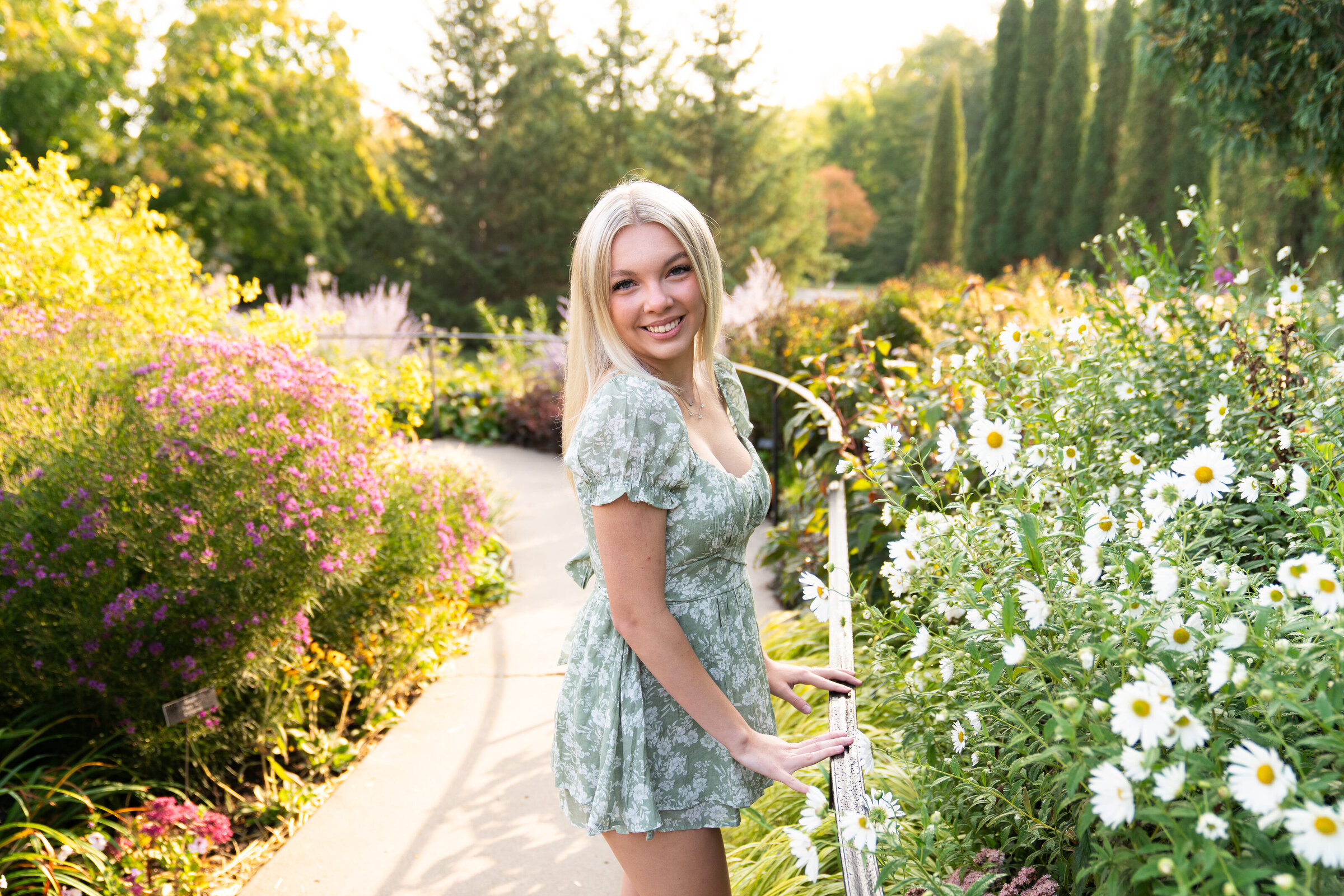 Girl poses next to flowers at the Minnesota Landscape Arboretum in Chaska, Minnesota