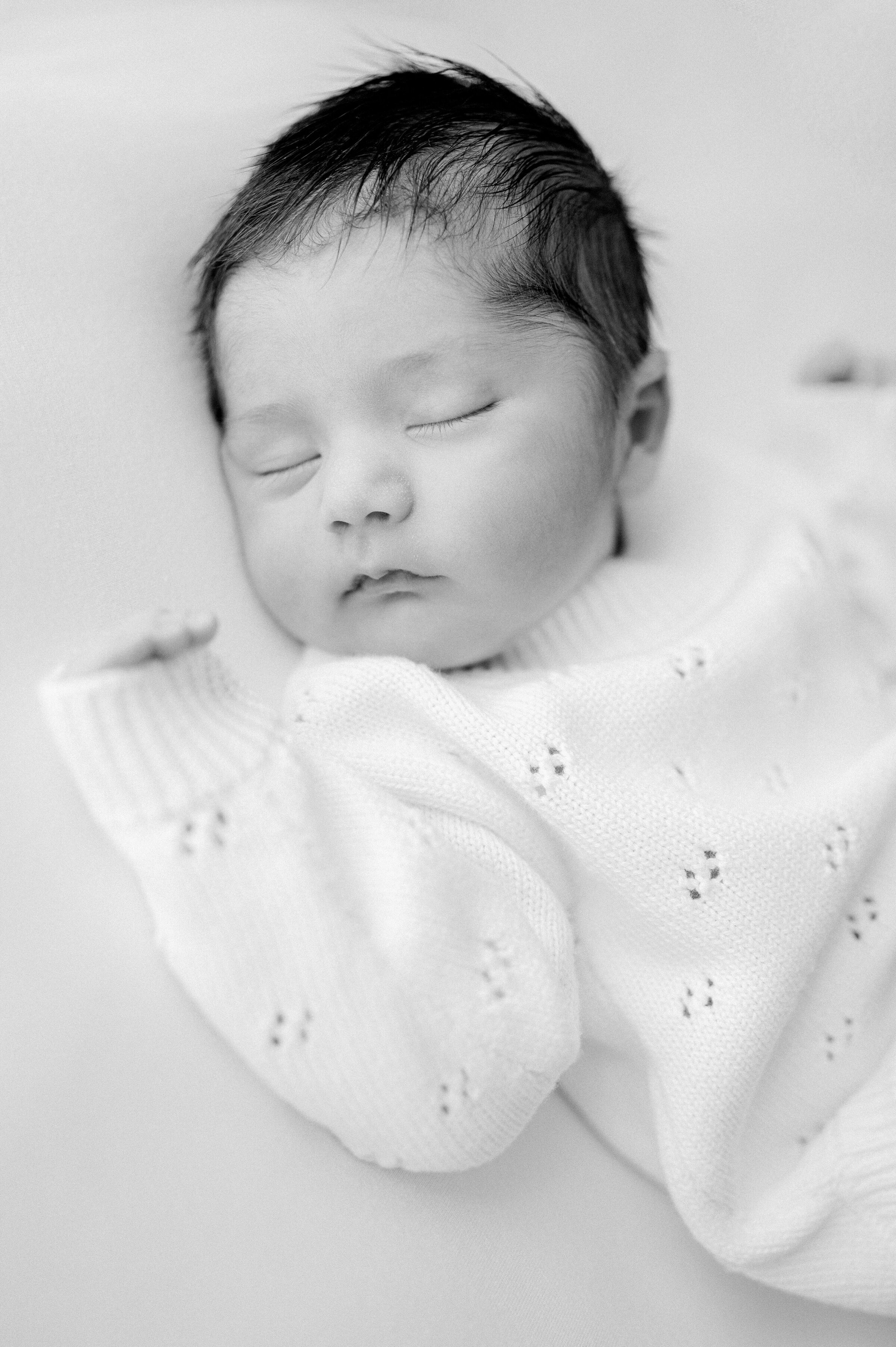 Baby boy sleeping black and white