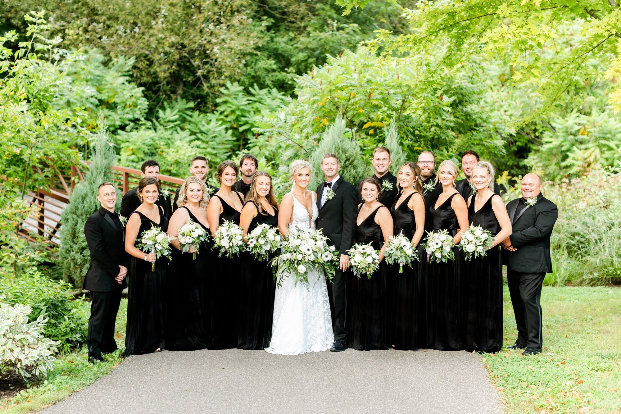 Bridal party in black, and bride in white, taken by wedding photographers minneapolis