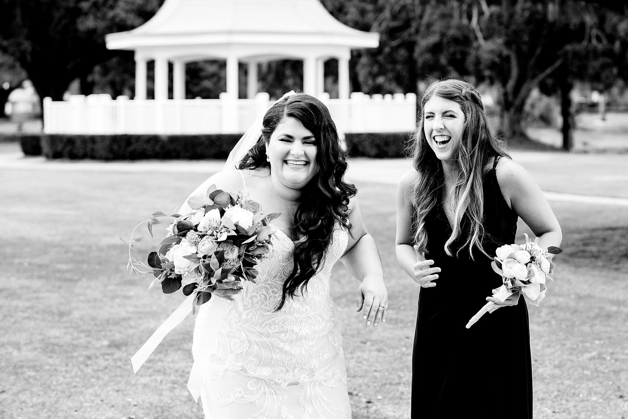 Black and White Photo of bride laughing with her maid of honor