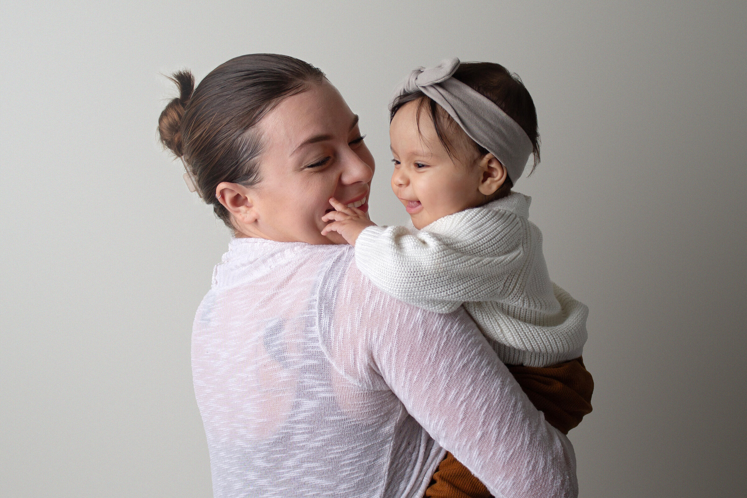 A candid moment between a little girl and her mom, captured by Minot children photographer.