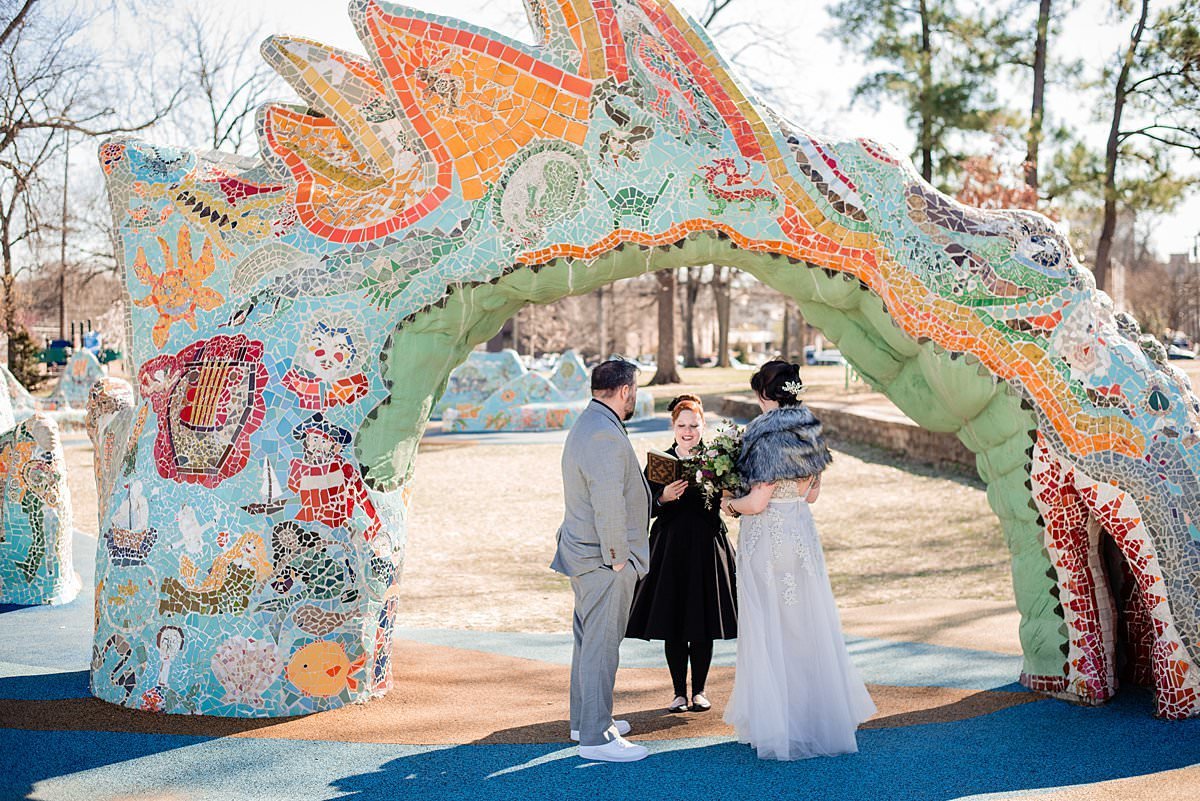 Elope in Tennessee elopement at the dragon park in Nashville, groom in a grey suit and bride wearing a fur shawl