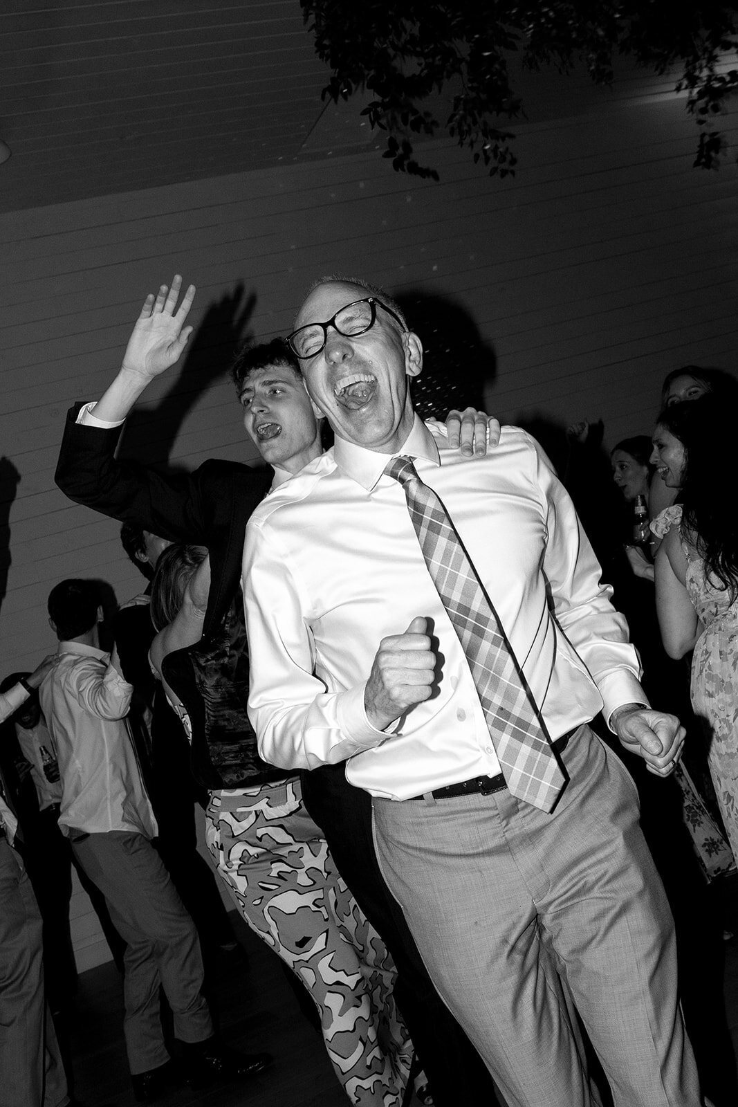 Guests form a congo line and enjoy every moment of it at a wedding reception at Prospect House.