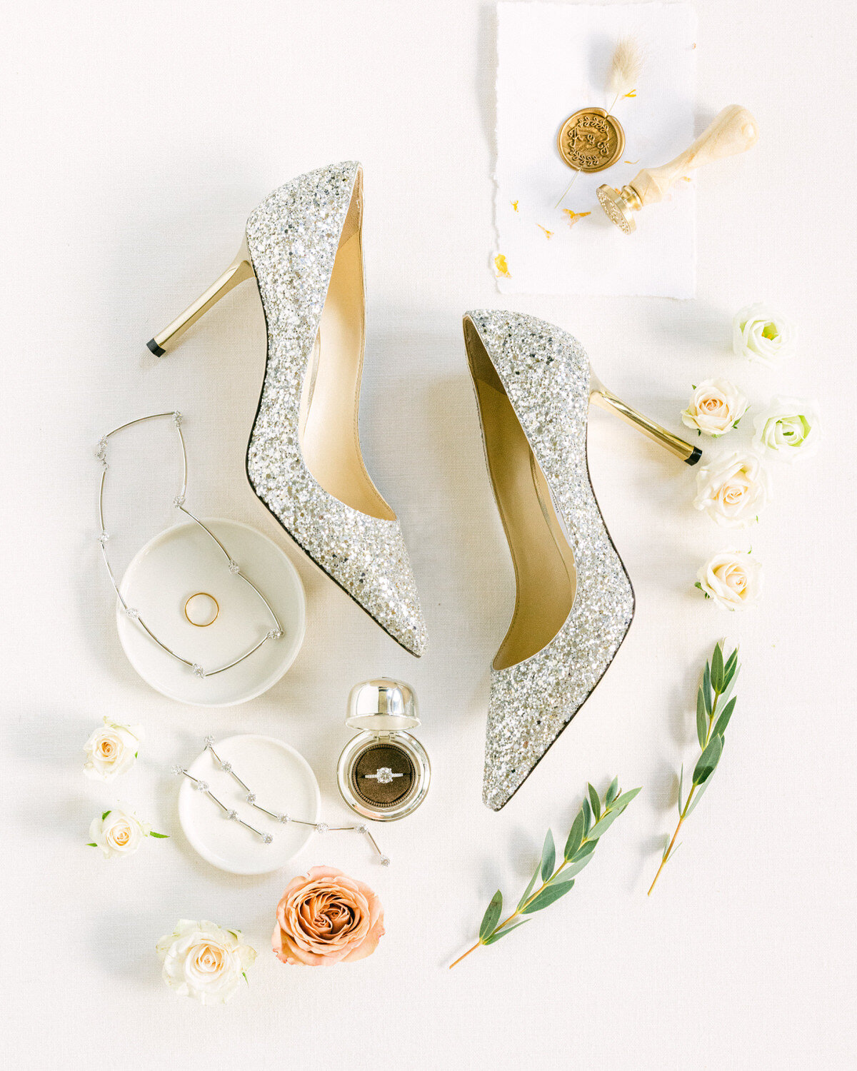 This beautifully composed layflat photograph captures the bride’s wedding day details in the morning, showcasing the elegant accessories and personal touches. Taken by a luxury photographer, the image highlights the meticulous attention to detail and sophistication of the bridal preparations.