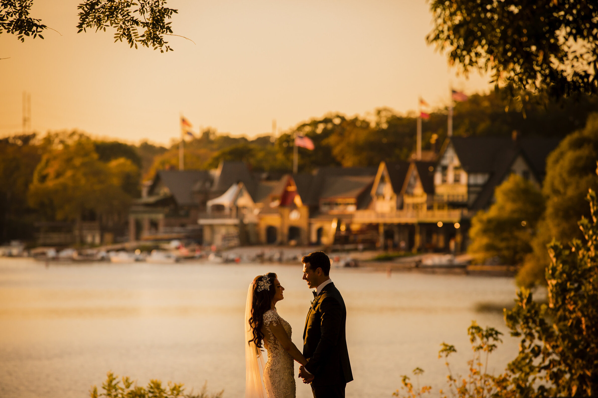 Sunset view of the bride and groom silhouette with the boat house row in the background at Water Works Philadelphia