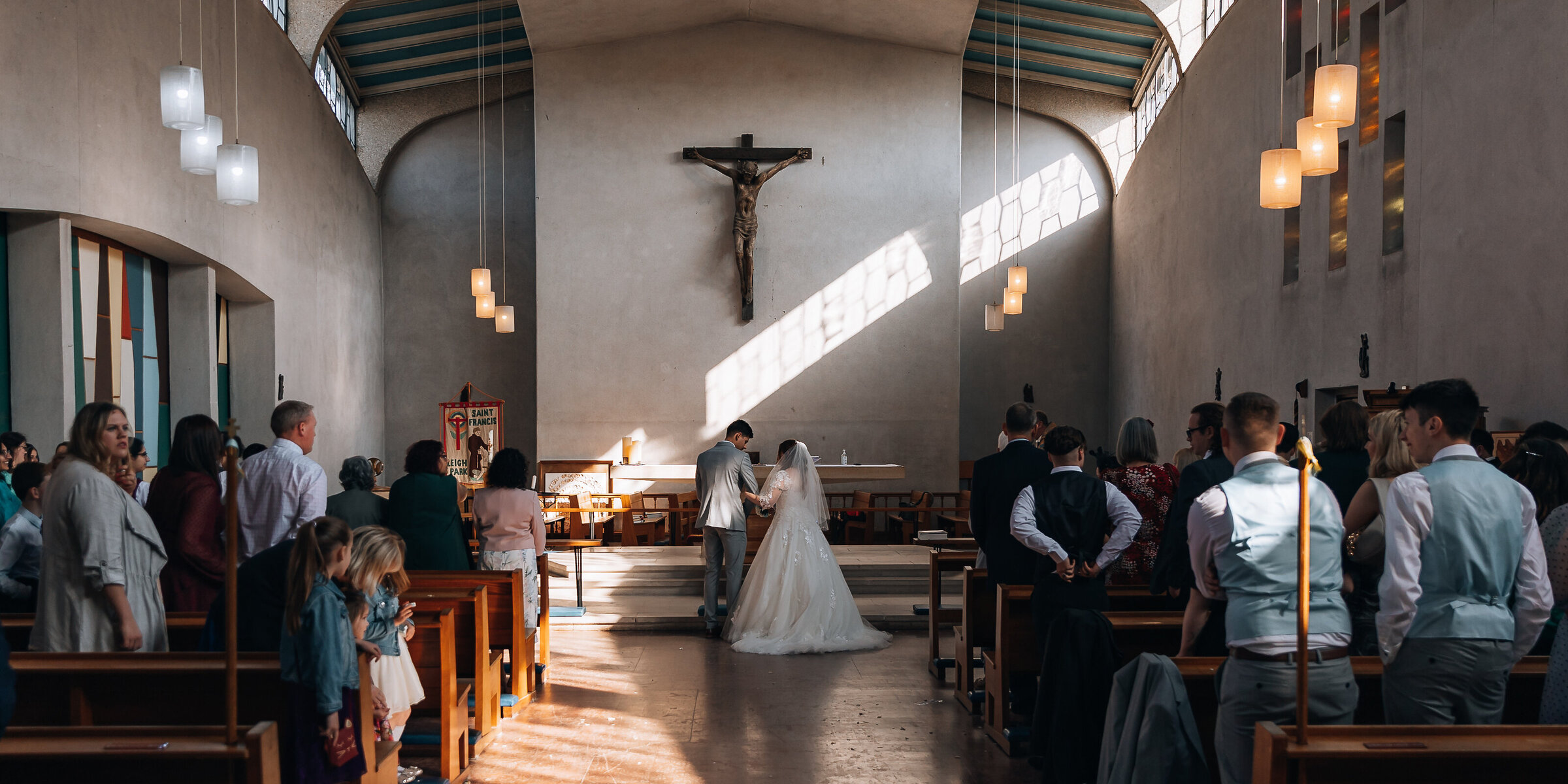 bride and groom at the alter in a large catholic cburch
