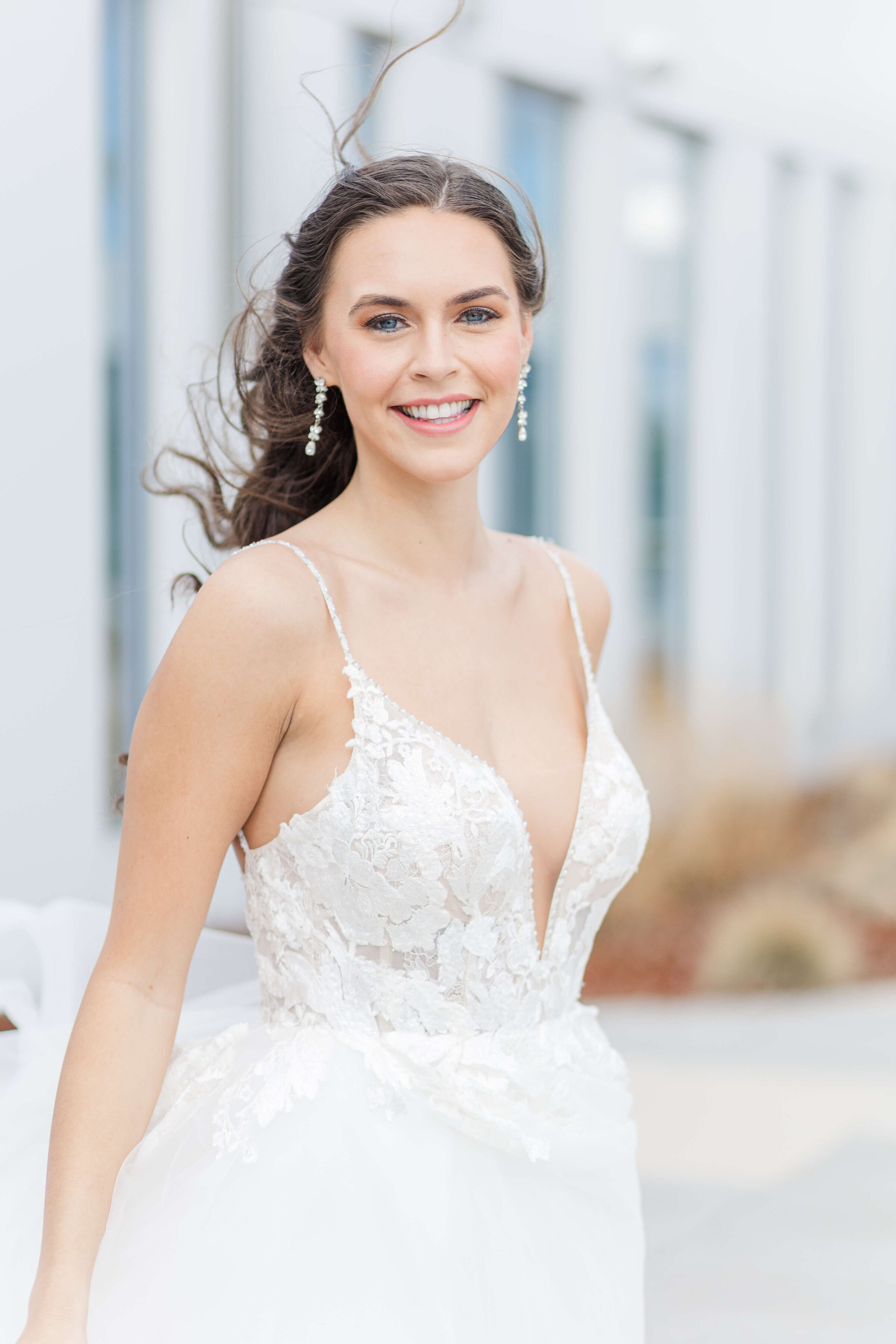 A bride stands on the rooftop of the Summit Hotel in Cincinnati Ohio. She is is smiling.