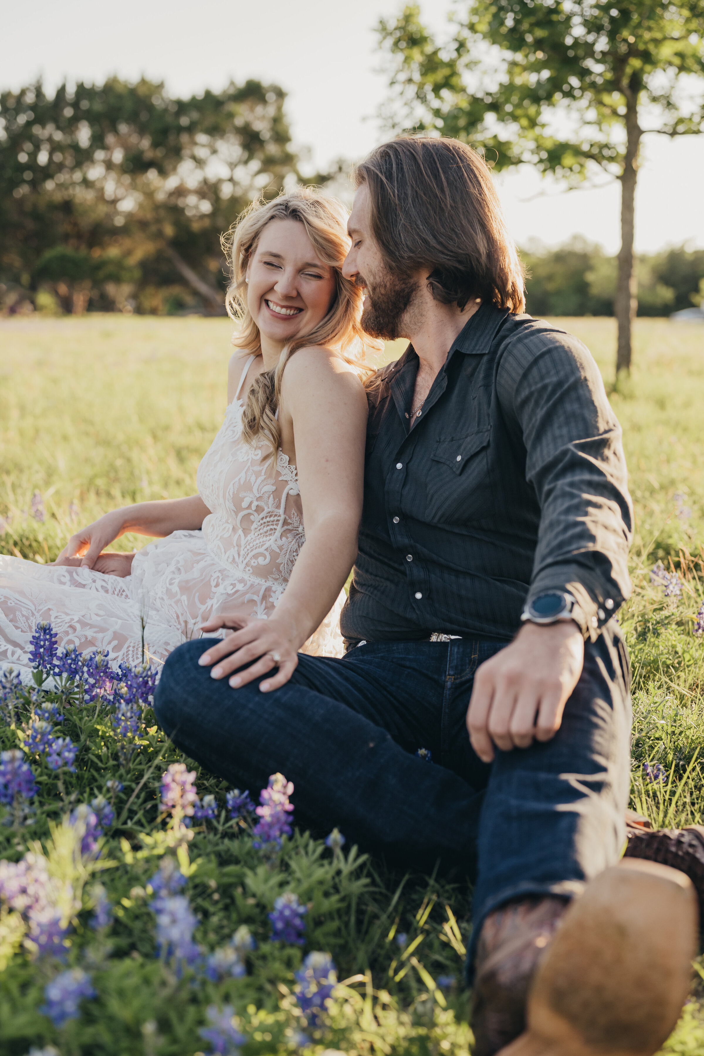 engaged-couple-laughing-in-bluebonnets