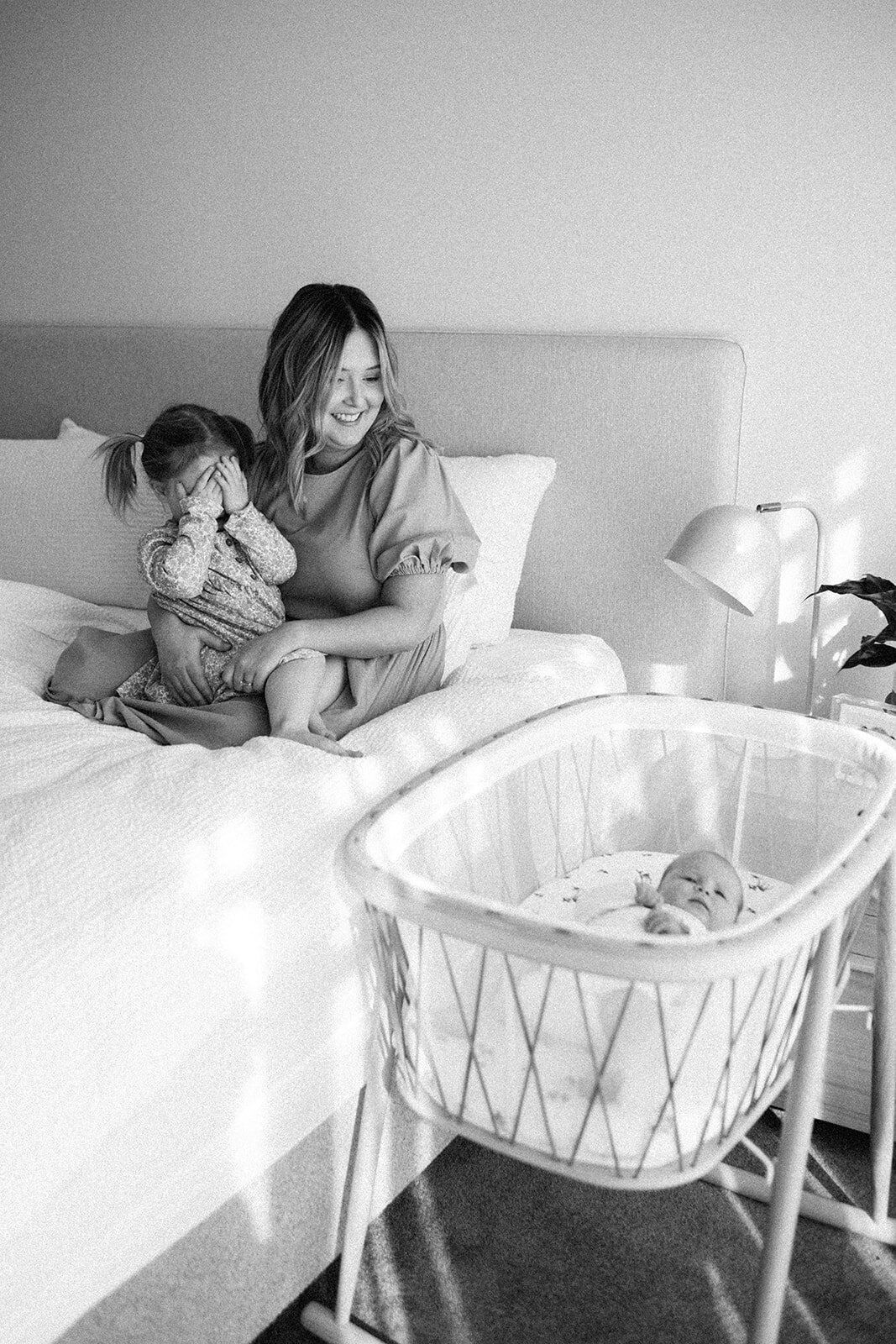 toddler playing peekaboo during a newborn in home session in melbourne