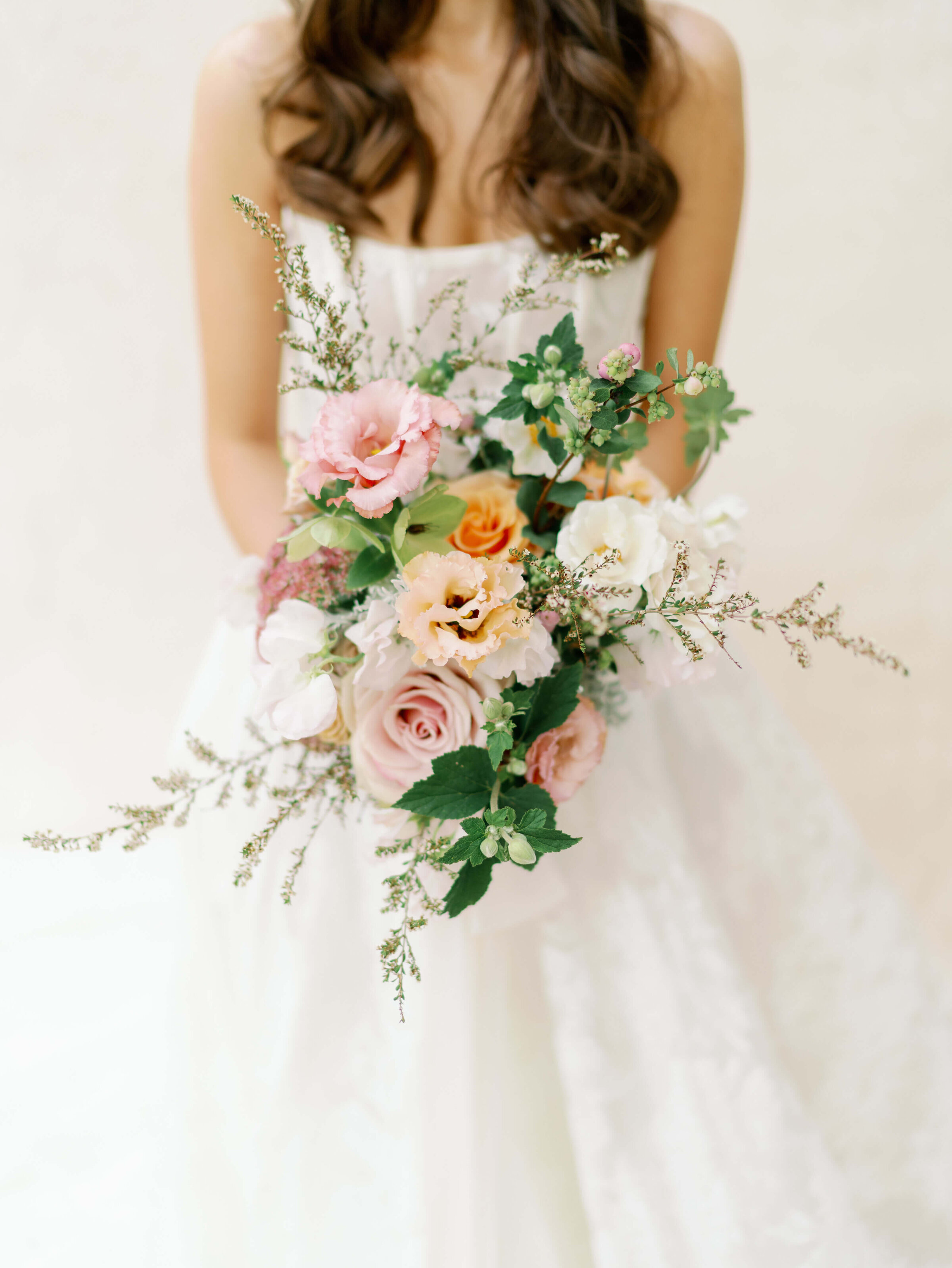 Bride holding floral bouquet by best wedding planners in chicago