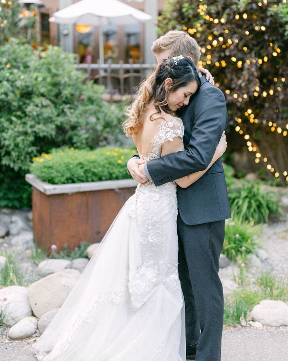 In this intimate moment, the bride and groom share a quiet embrace outside the River Café during their evening reception. Taking a few minutes for themselves, their love and connection are beautifully captured against the charming evening backdrop, creating a peaceful, heartfelt scene.