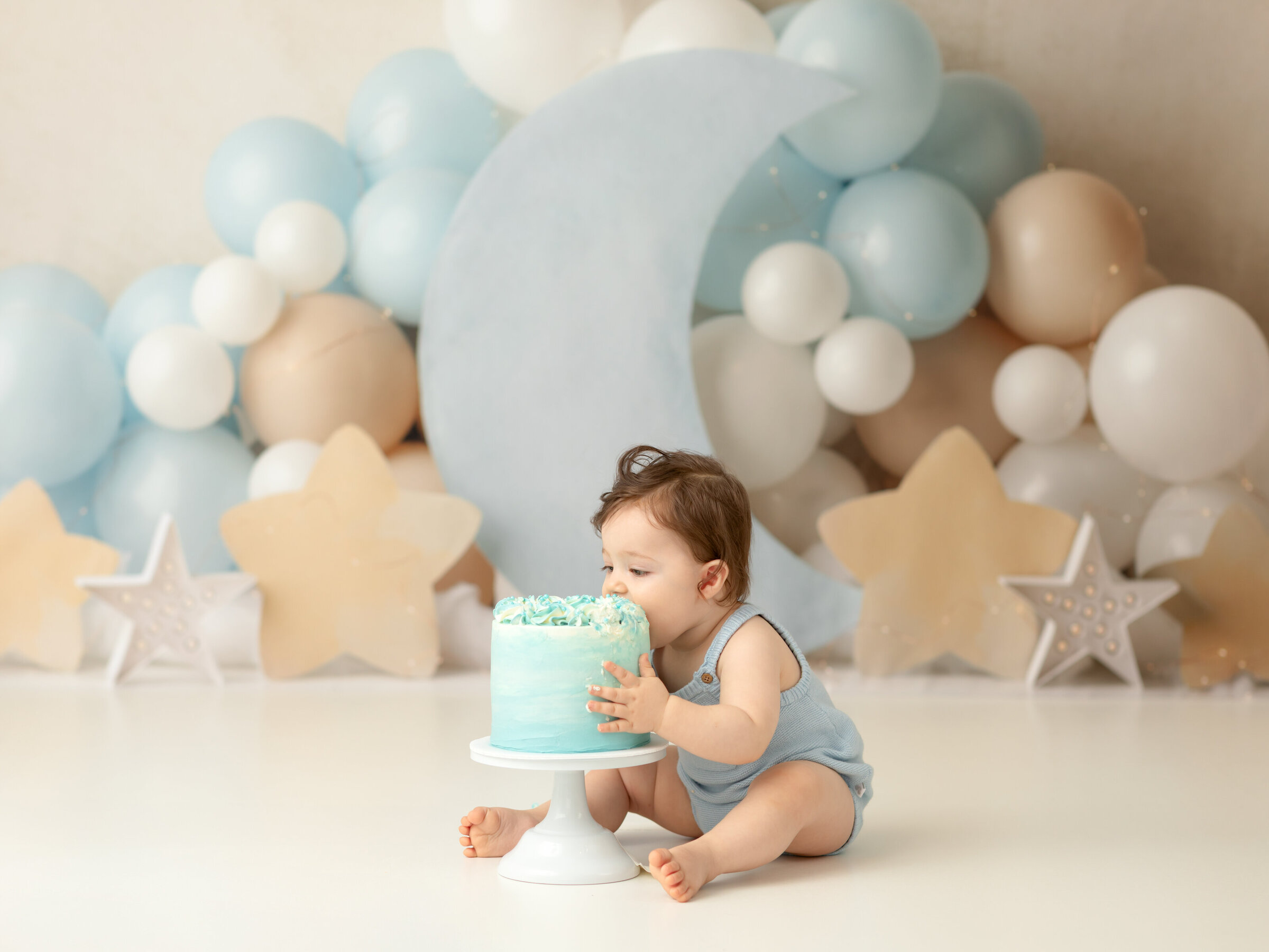 one year old boy eating cake for first birthday cake smash Cleveland family photographer