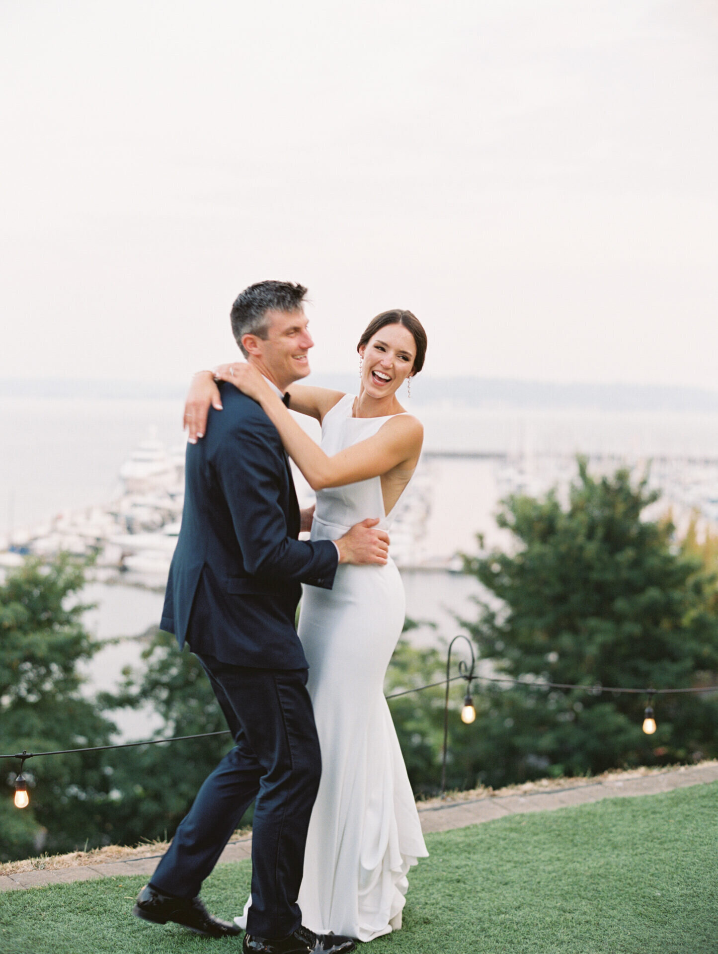 laughing bride and groom dancing