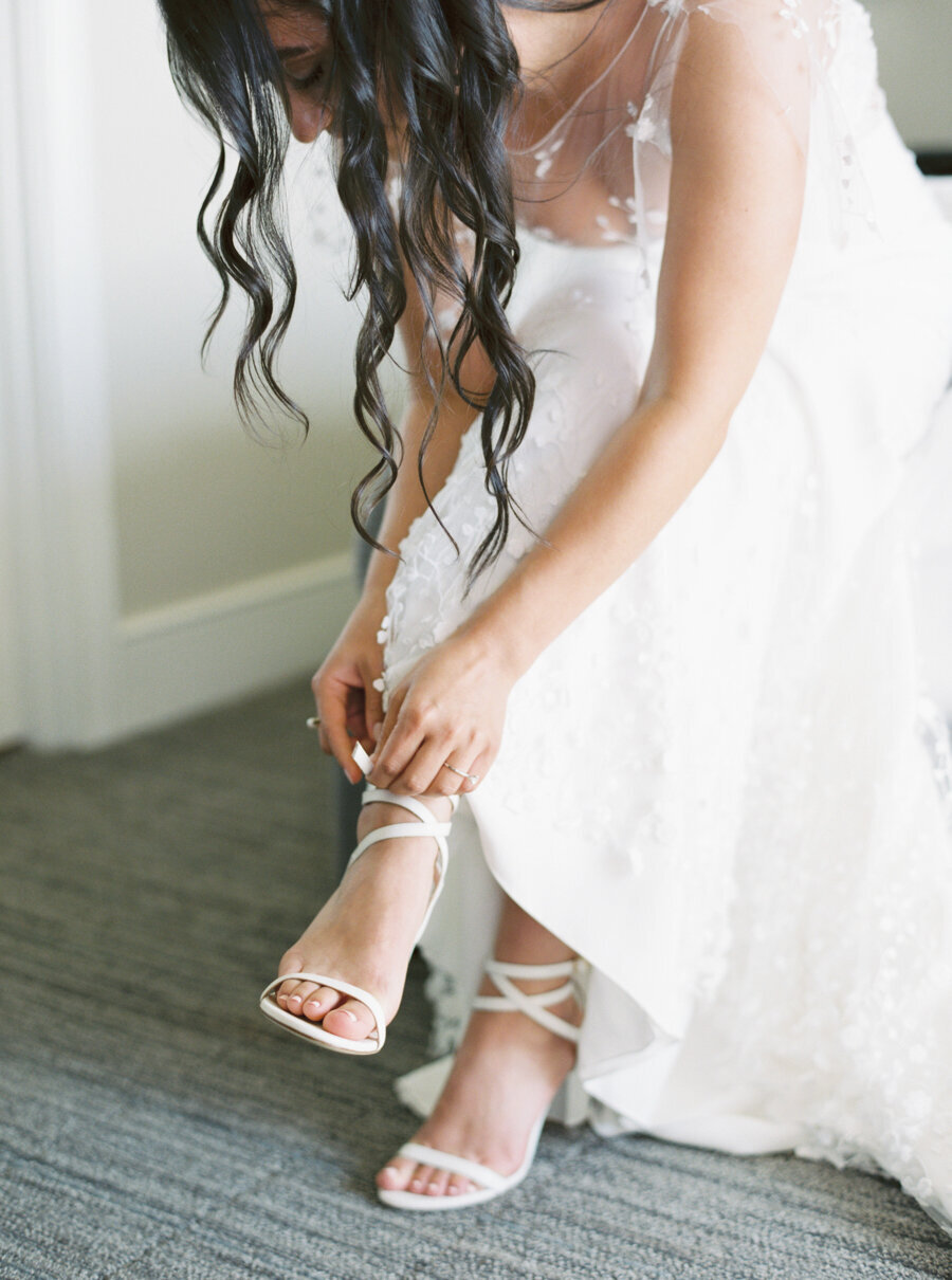 bride buckling her shoes