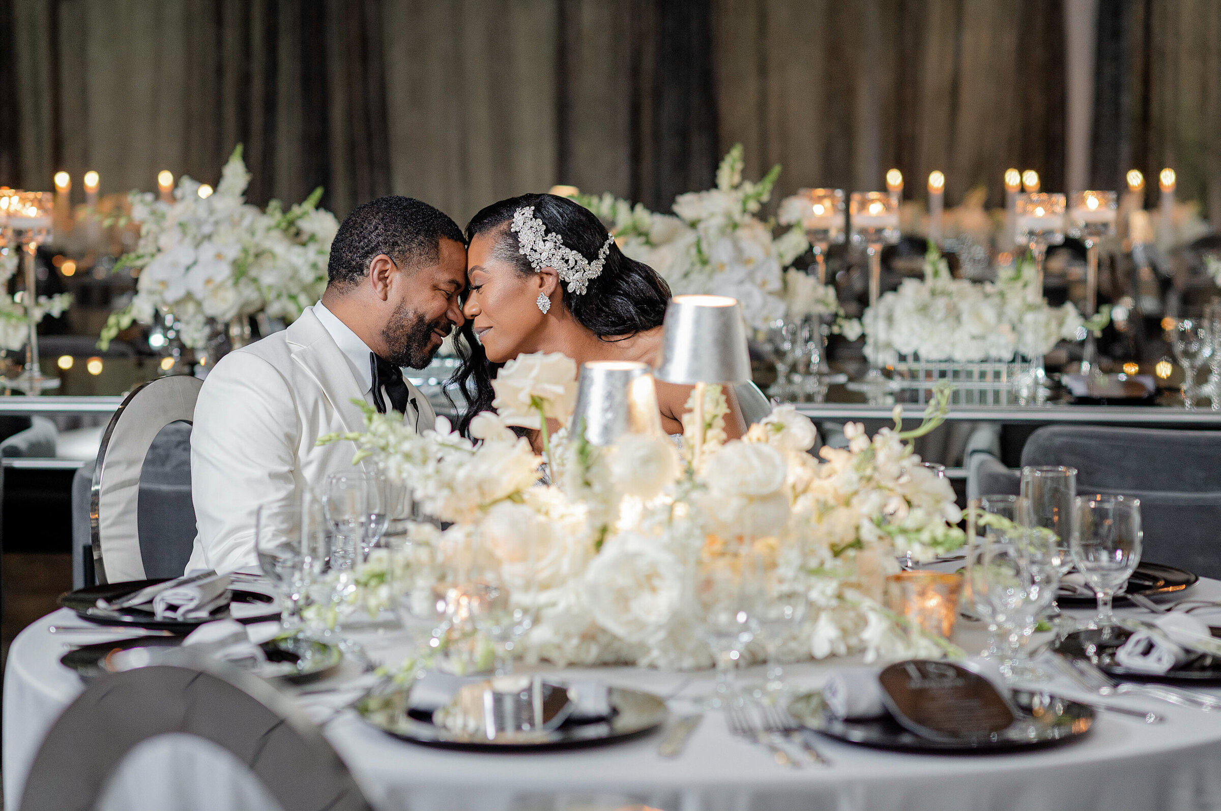 Elegant gray and white wedding reception decor with luxury floral centerpieces by Wells Design Co.