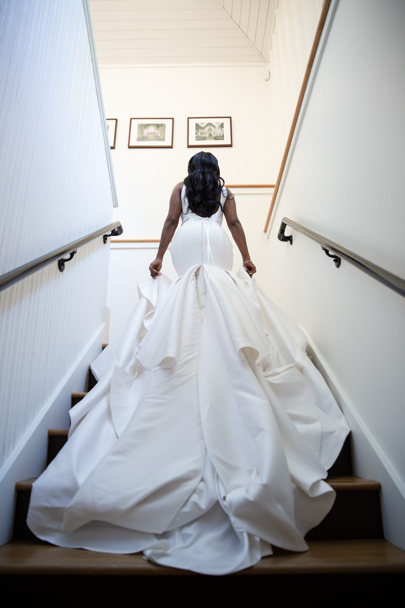 bride walking up the stairs in All Saints Chapel downtown Raleigh, NC