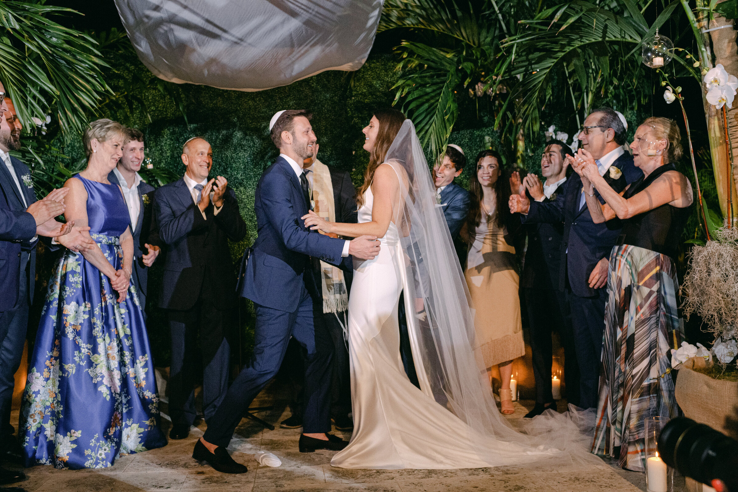 Bride and groom smiling under the chuppah during an intimate Jewish wedding ceremony in Washington DC, captured by Mari Harsan Studios.