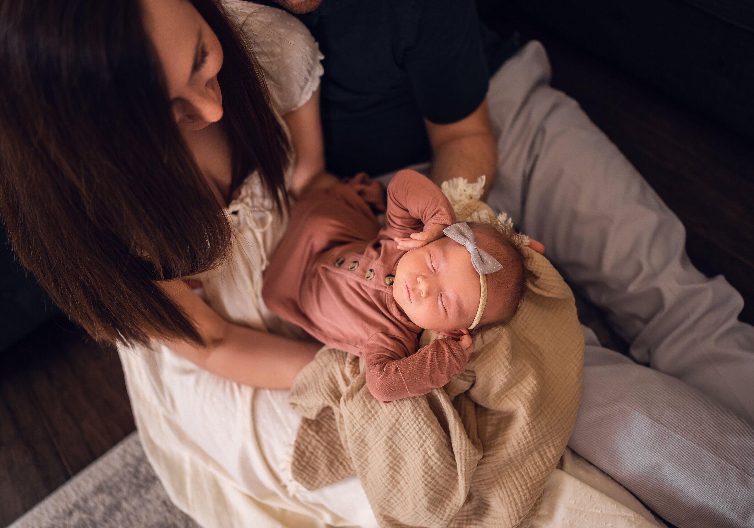 Parents holding newborn baby girl