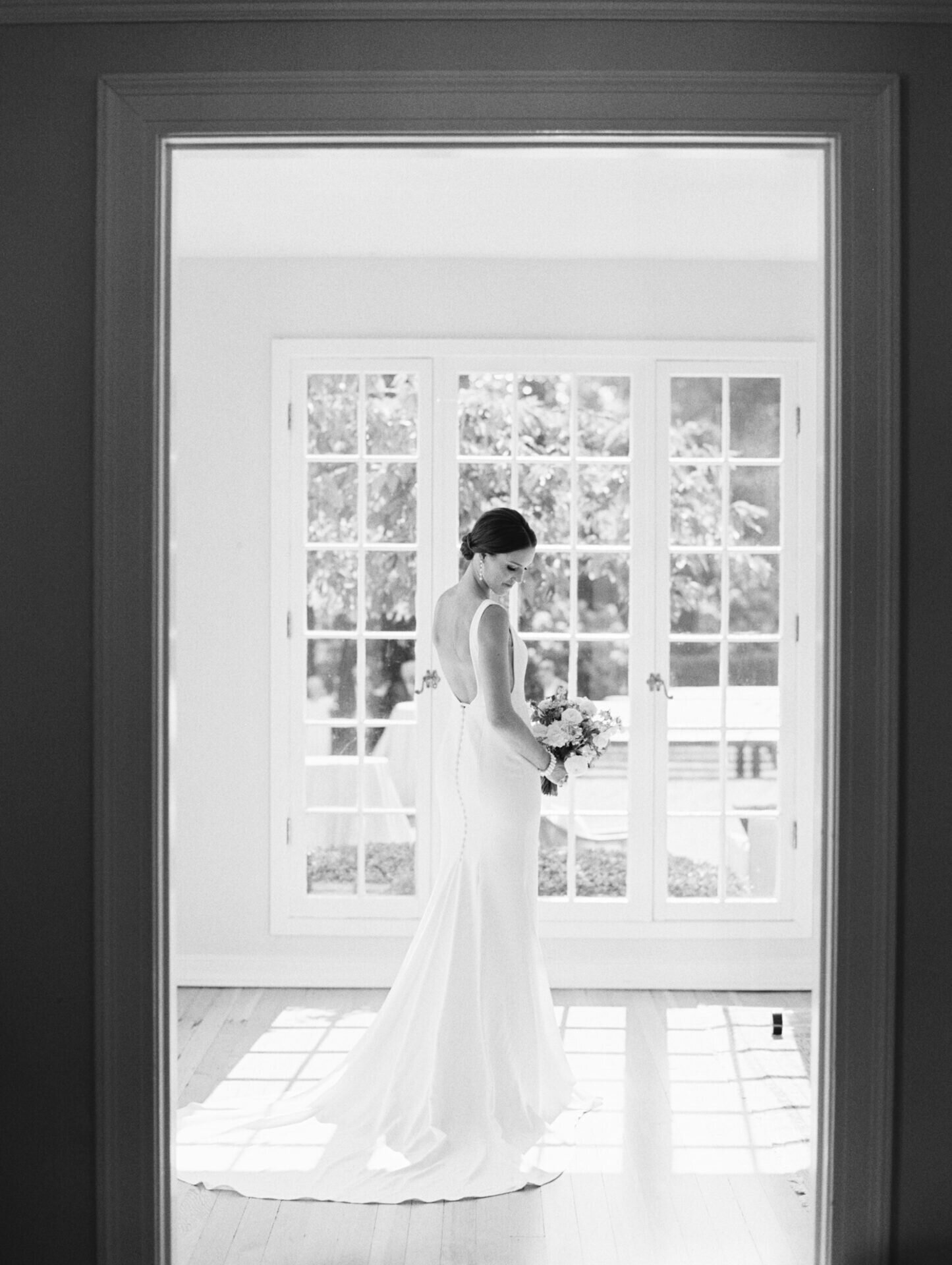 black and white portrait of bride in the window room at the admiral's house