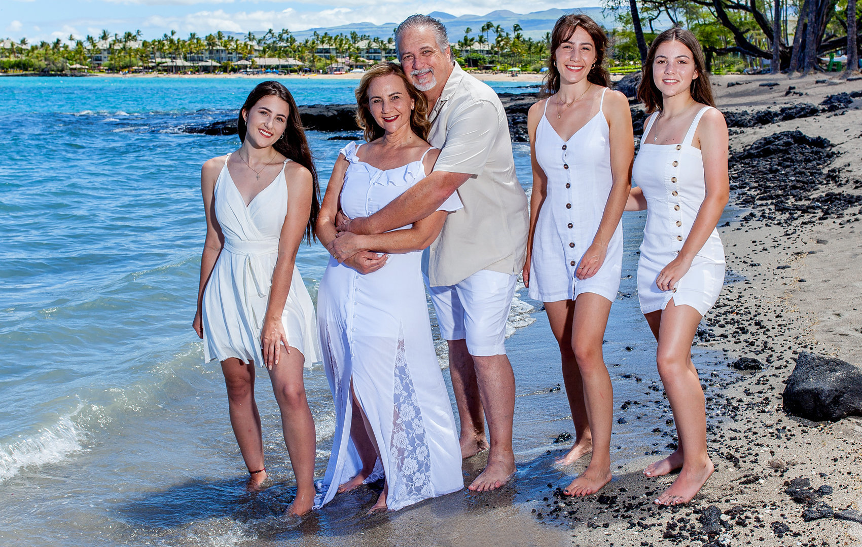 All in white and looking so bright, a family of five with three beautiful daughters.