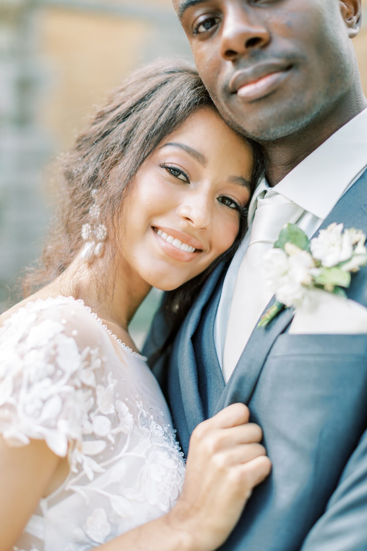 Stunning portrait of a bride and groom snuggled together outside of the Clifton Inn wedding venue.