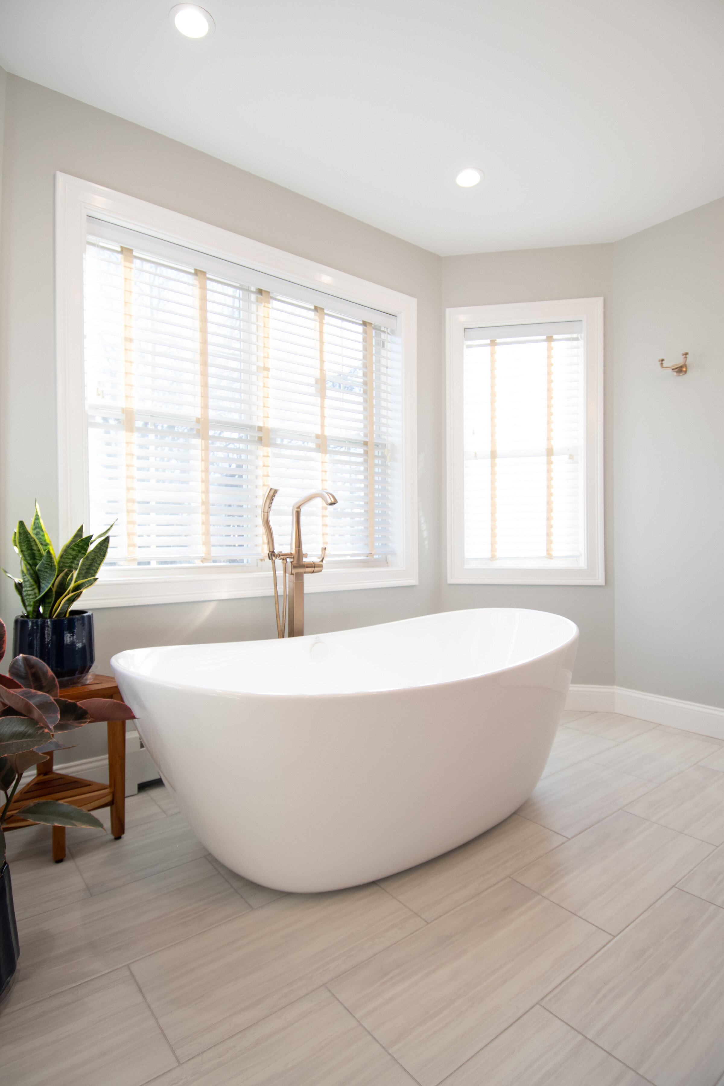 Free standing tub with lots of natural light coming in for this fresh bathroom remodel and design in Connecticut. 