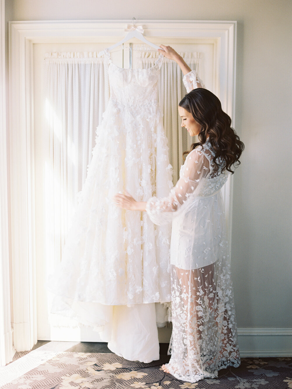 bride hanging her dress up