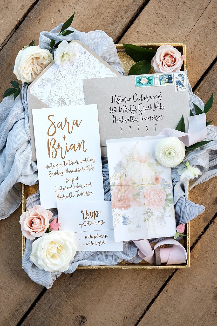 Soft blush, blues and ivory detailing around a calligraphy wedding invitation for Cedarwood Weddings