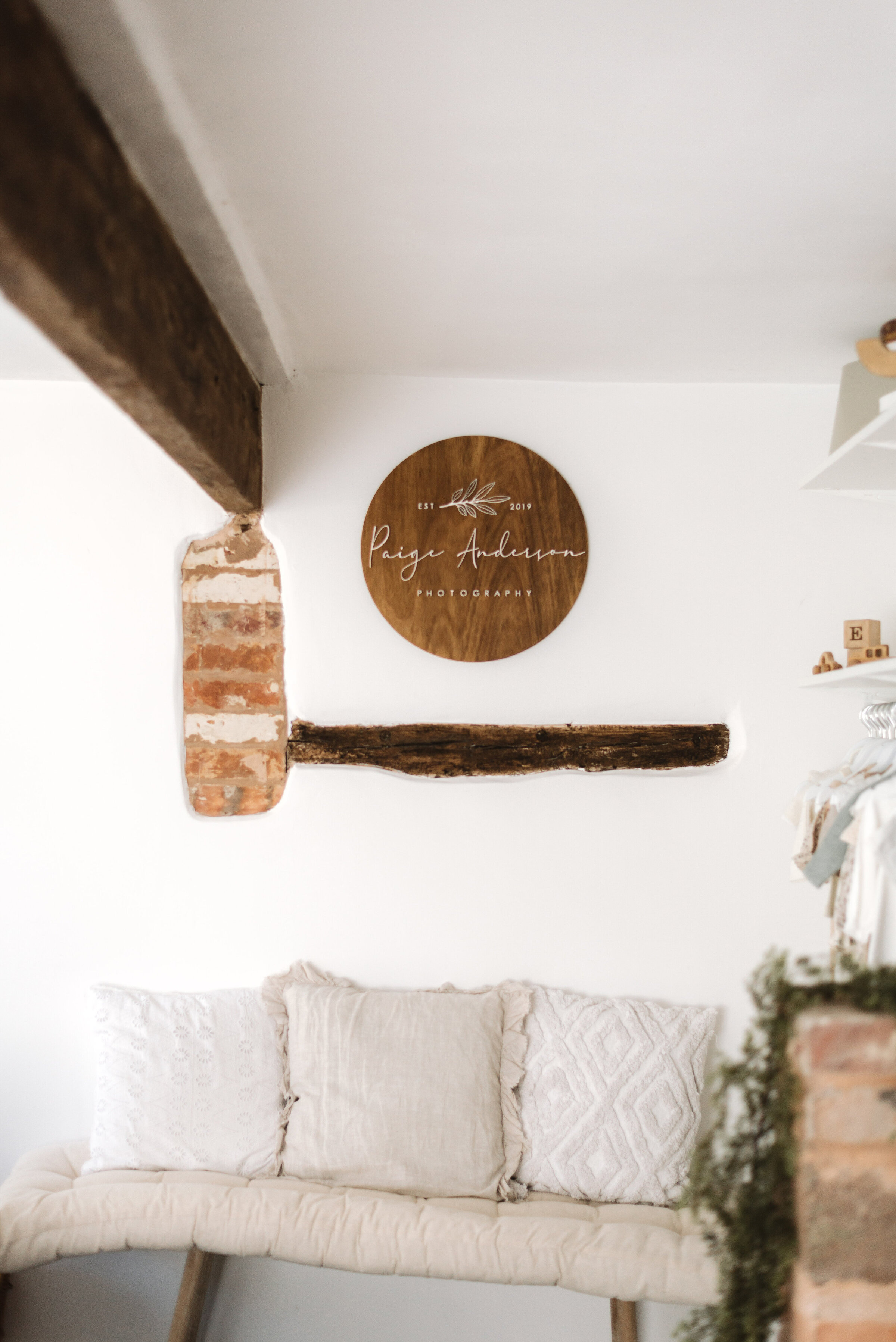 Newborn photography studio with brown beams and lots of great seating