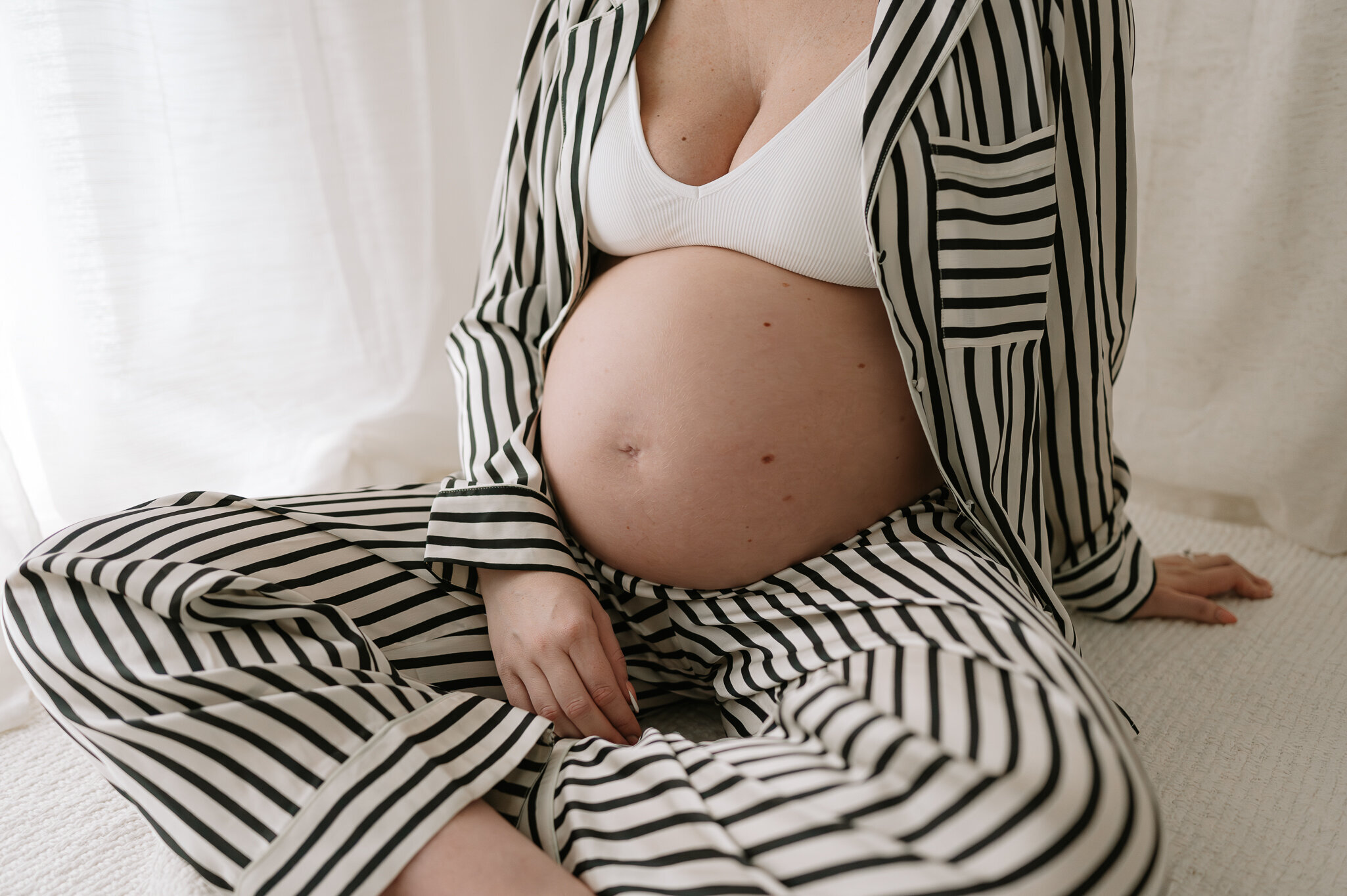 stripey pyjamas on pregnant Mum in studio