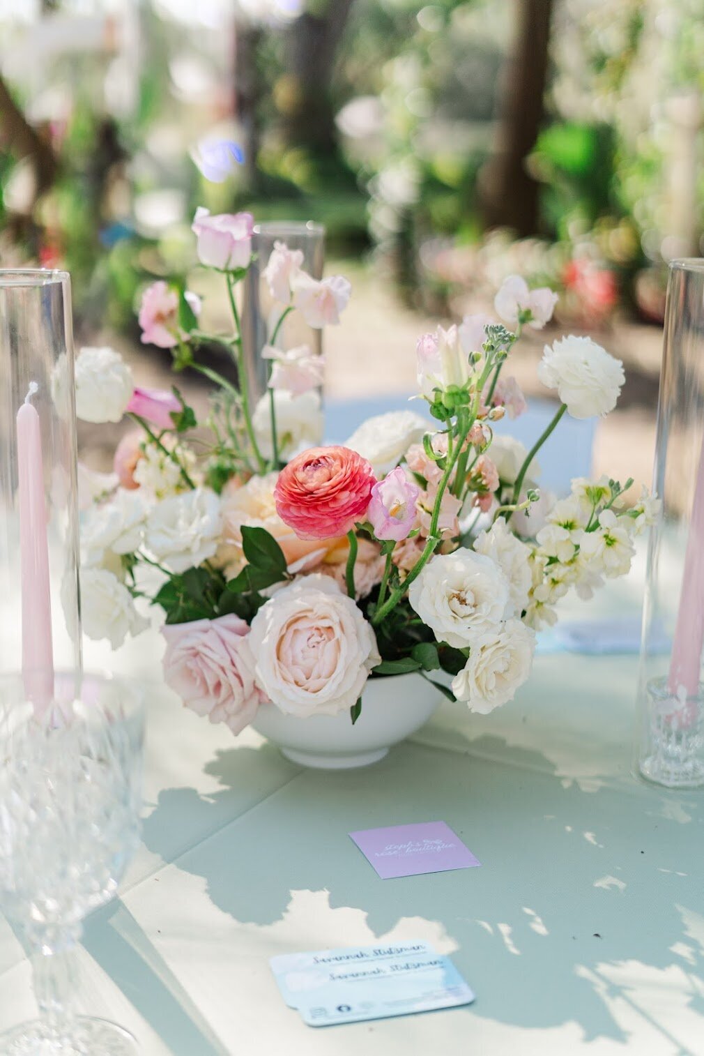 Close-up of pastel floral centerpiece with roses and greenery on a reception table at Uliana Estate in Lakeland, Florida

