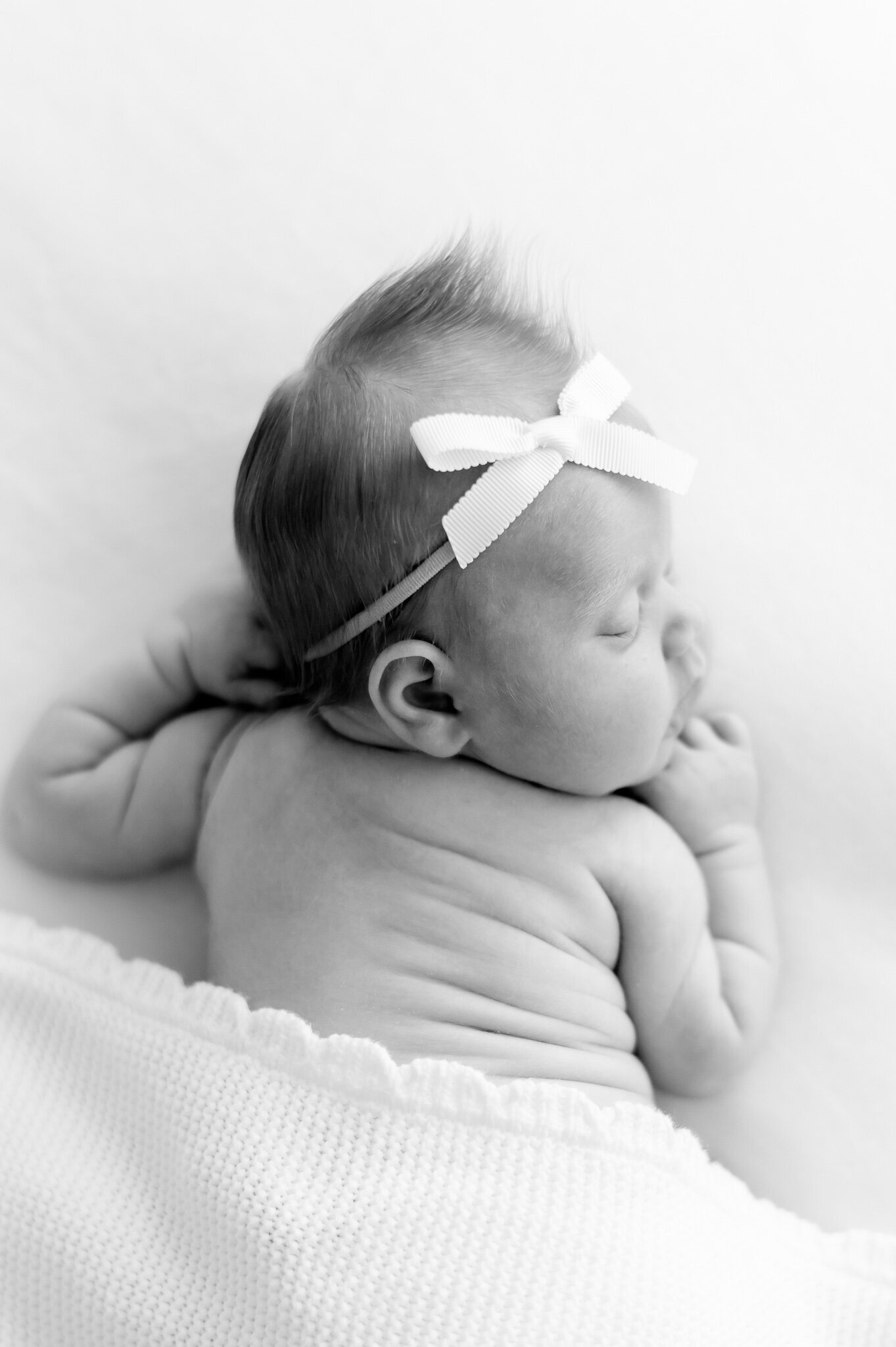 black and white image of a sleeping newborn with back wrinkles