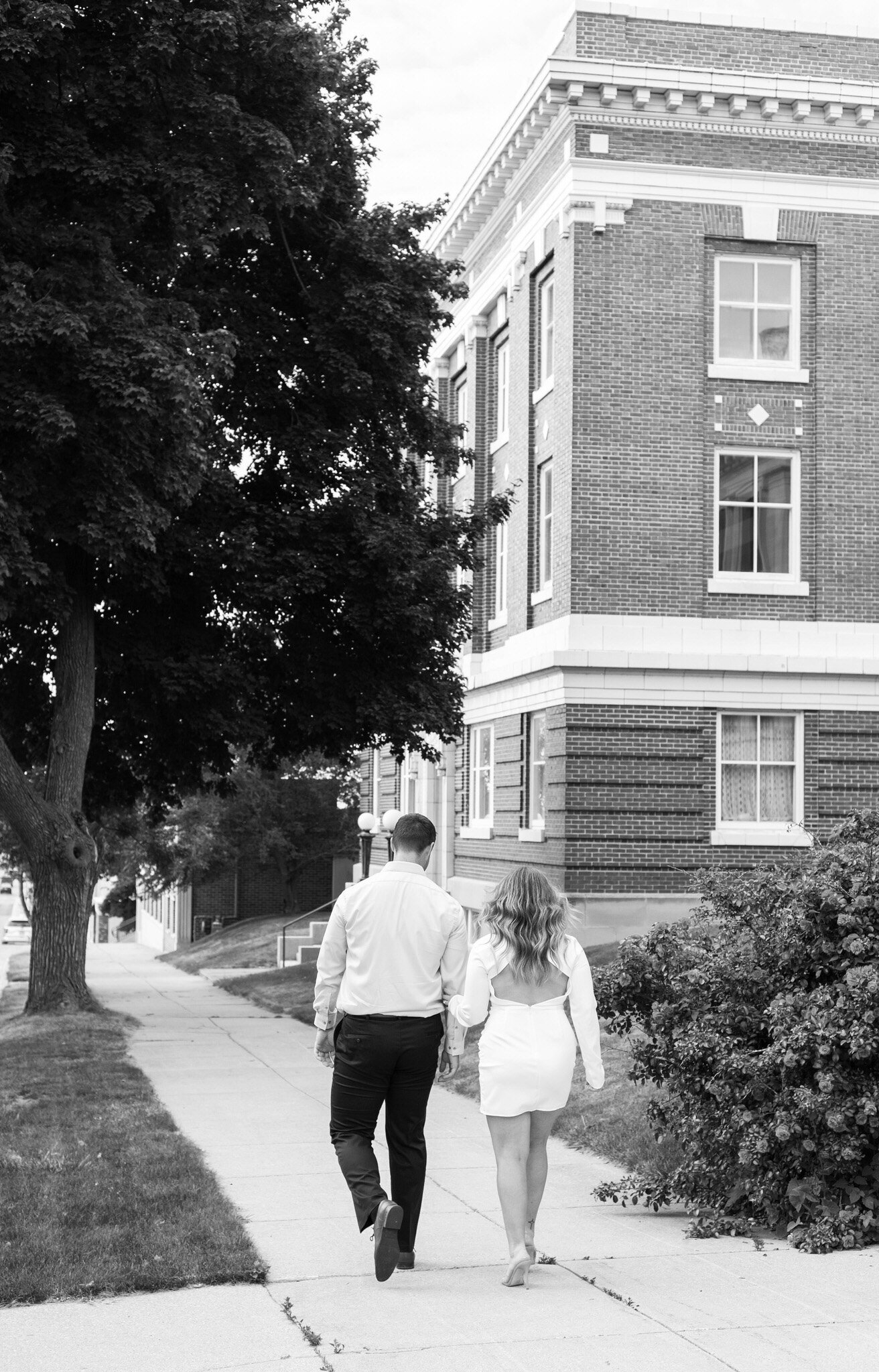 couple walking in front of the public library in Manistee