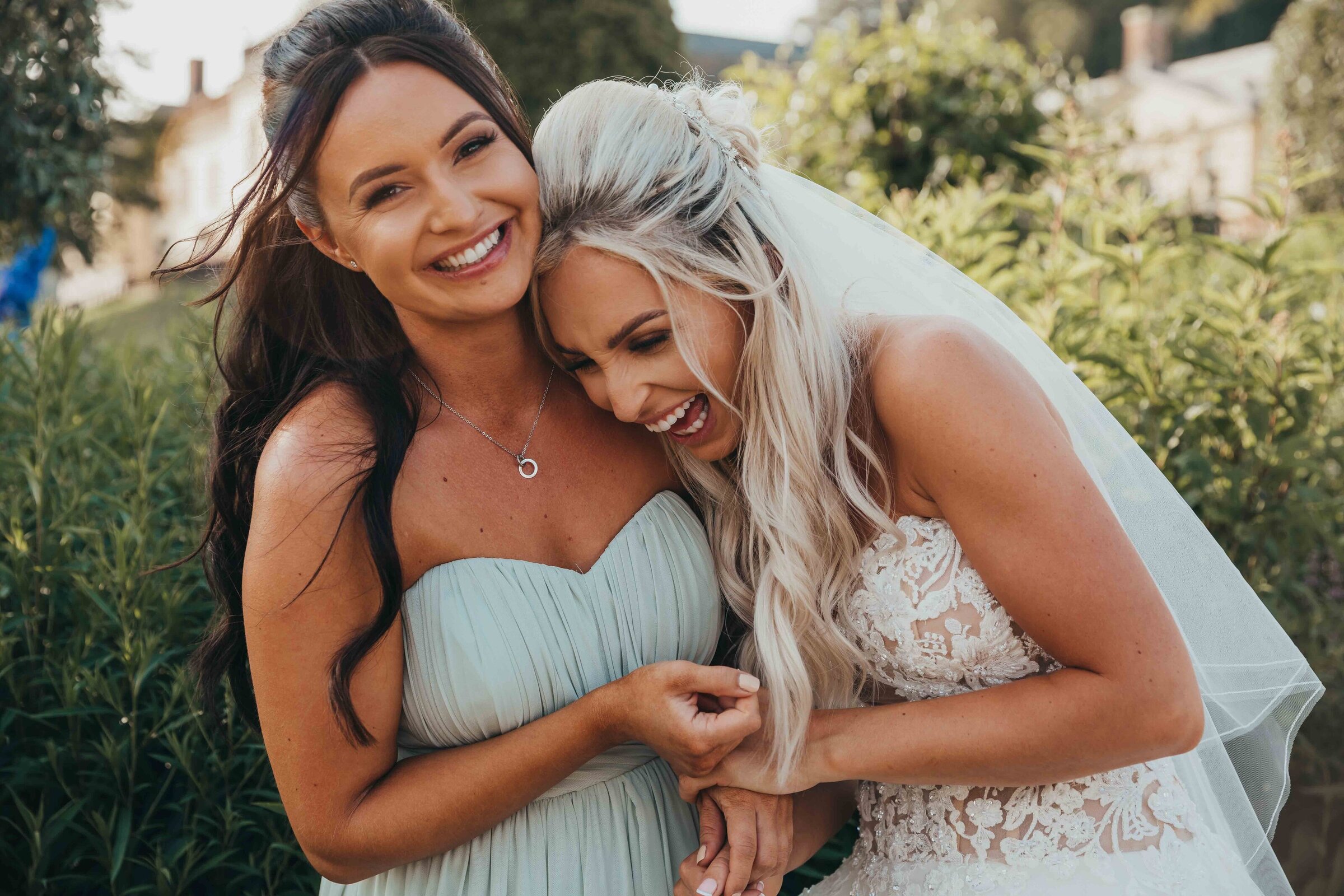 bride laughs with her maid of honour