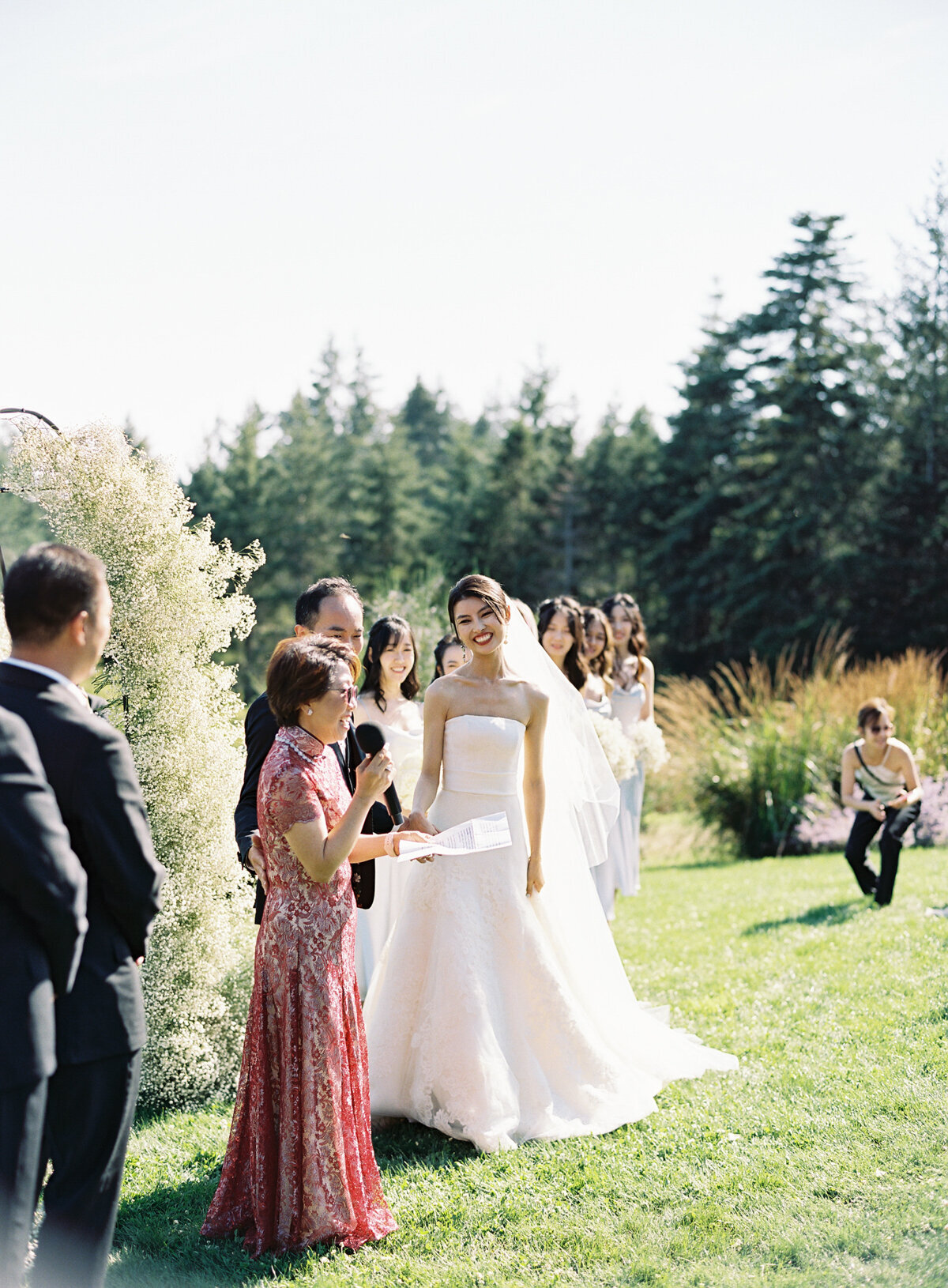 beautiful asian bride in white vera wang gown at outdoor sunny ceremony with veil