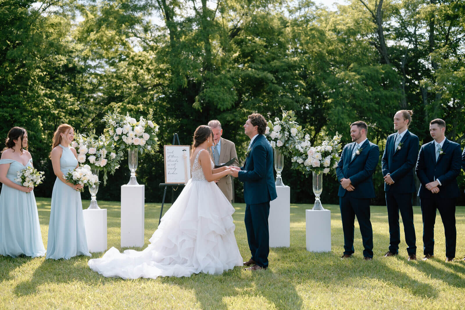 Bride and groom kissing in front of bridal party taken by wedding photographers in lexington