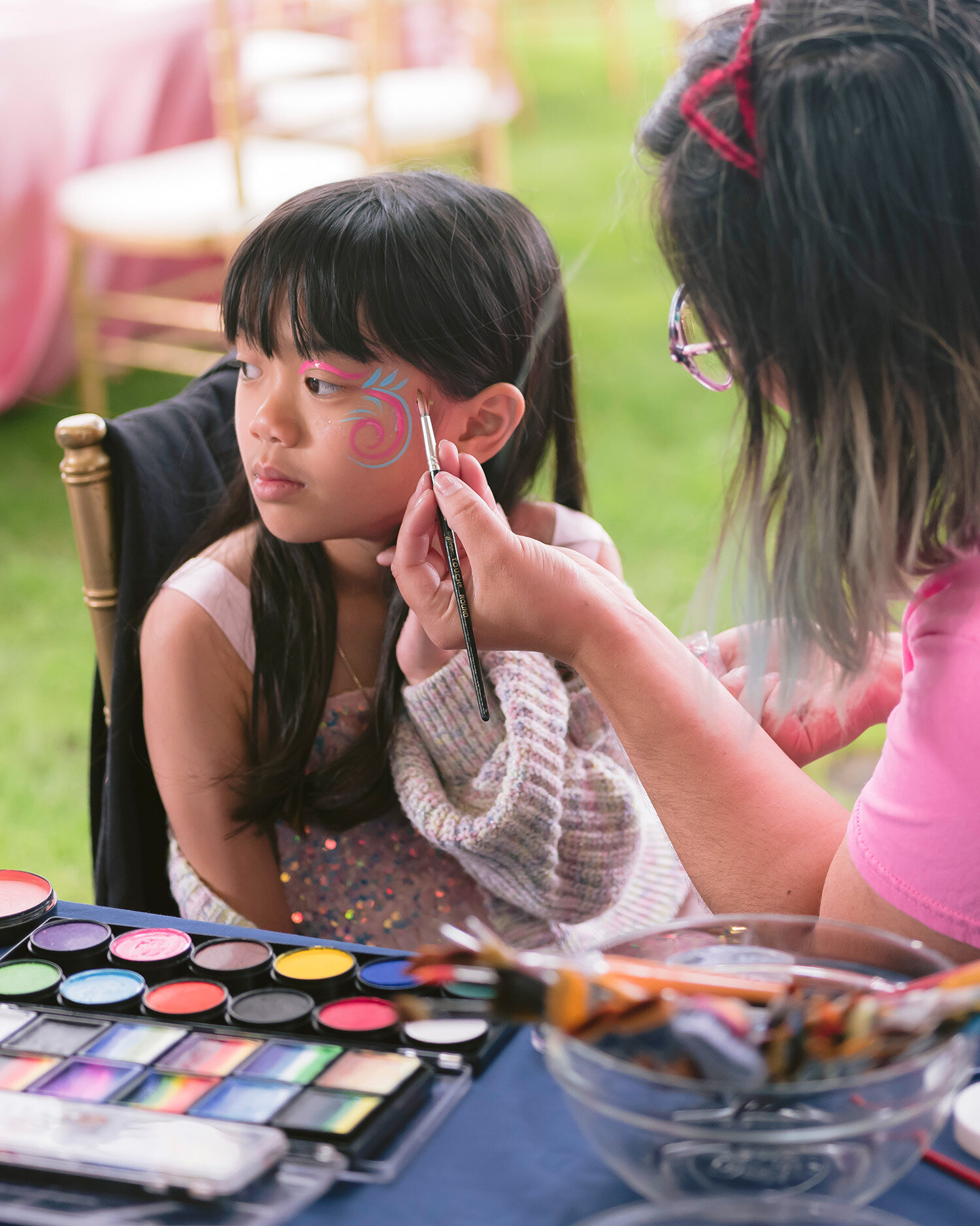Little girl getting her face painted at a first birthday party in San Francisco and the Bay Area